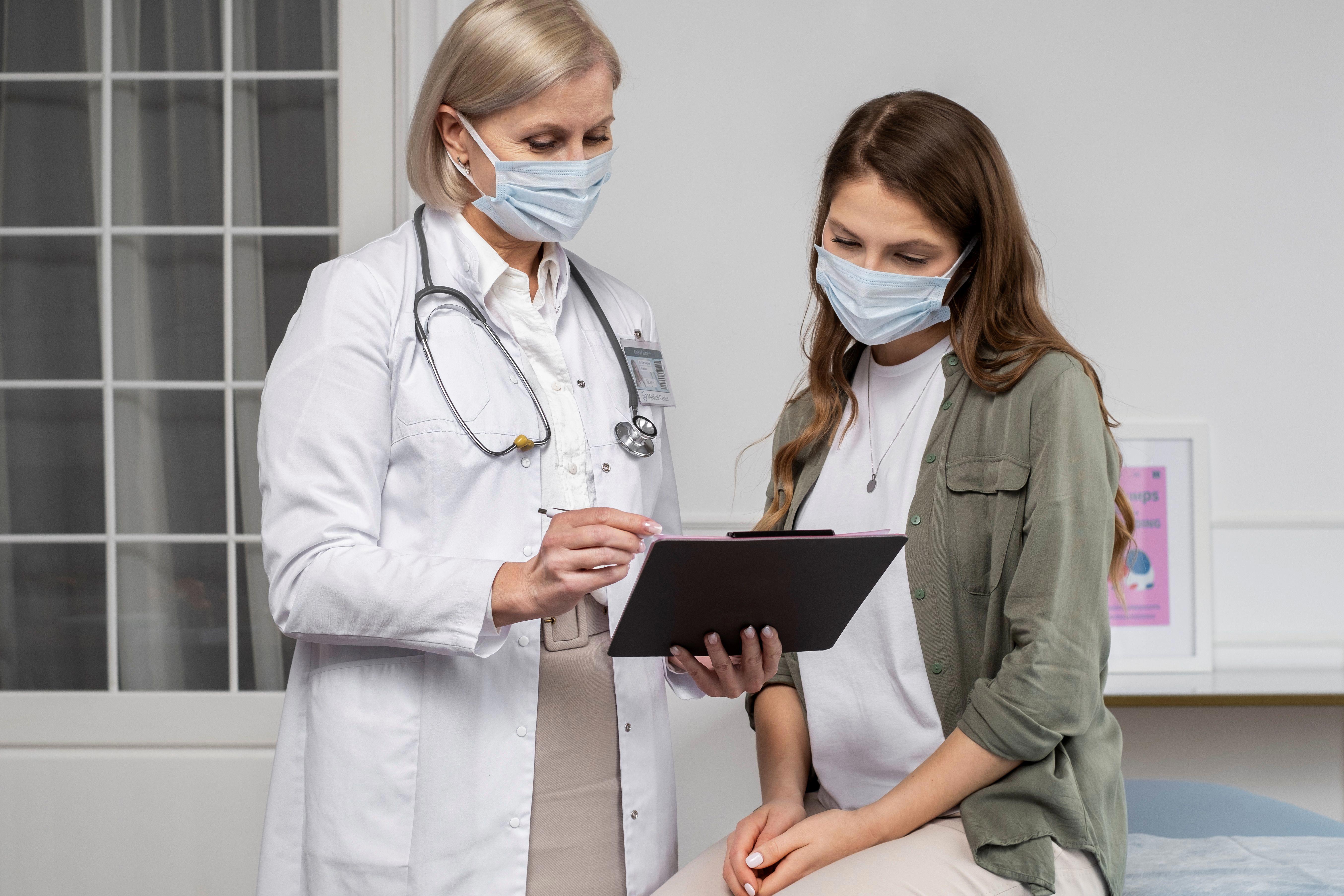 medium-shot-doctor-patient-wearing-masks