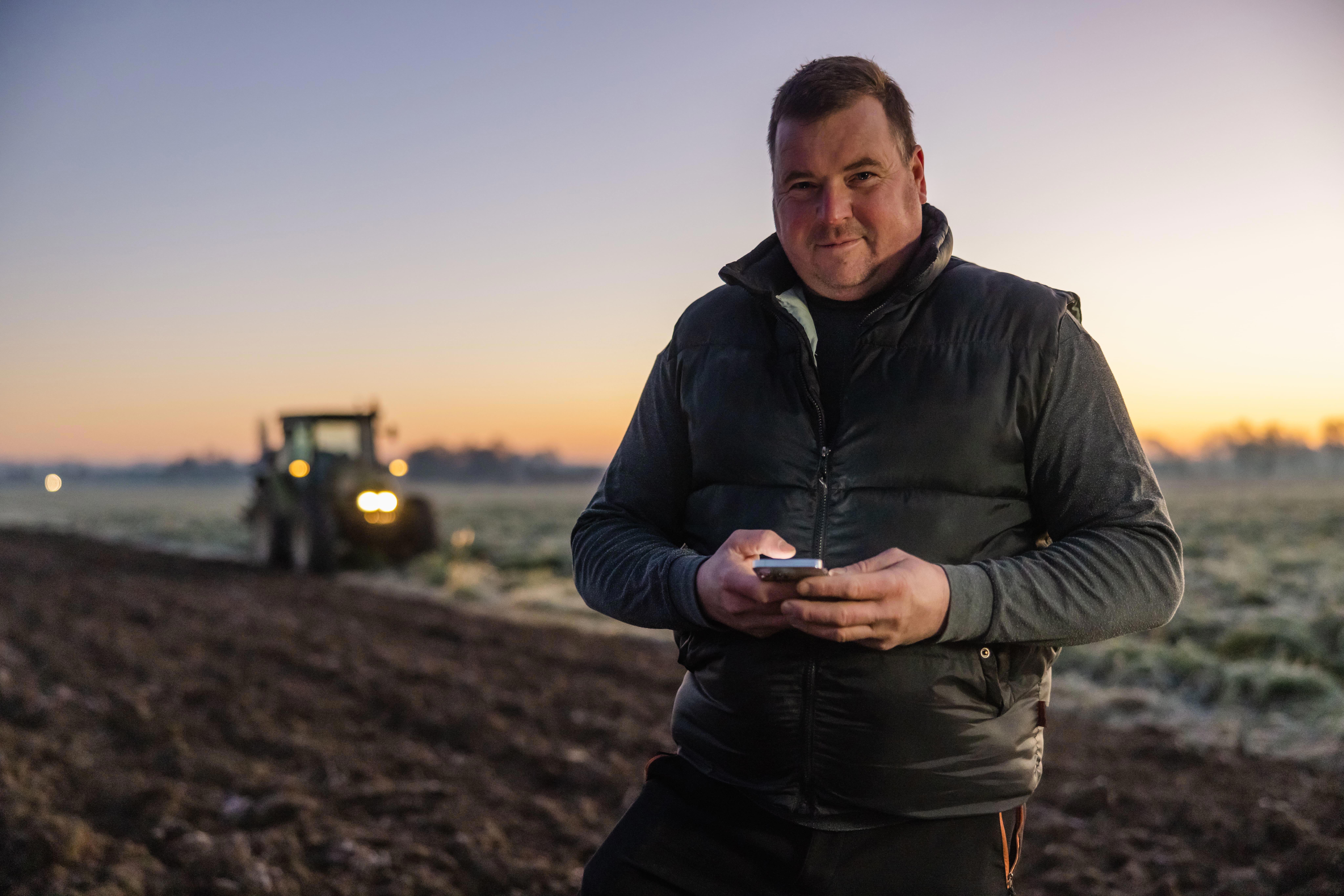 agro-farmer-outside-field-tractor-8192x5464