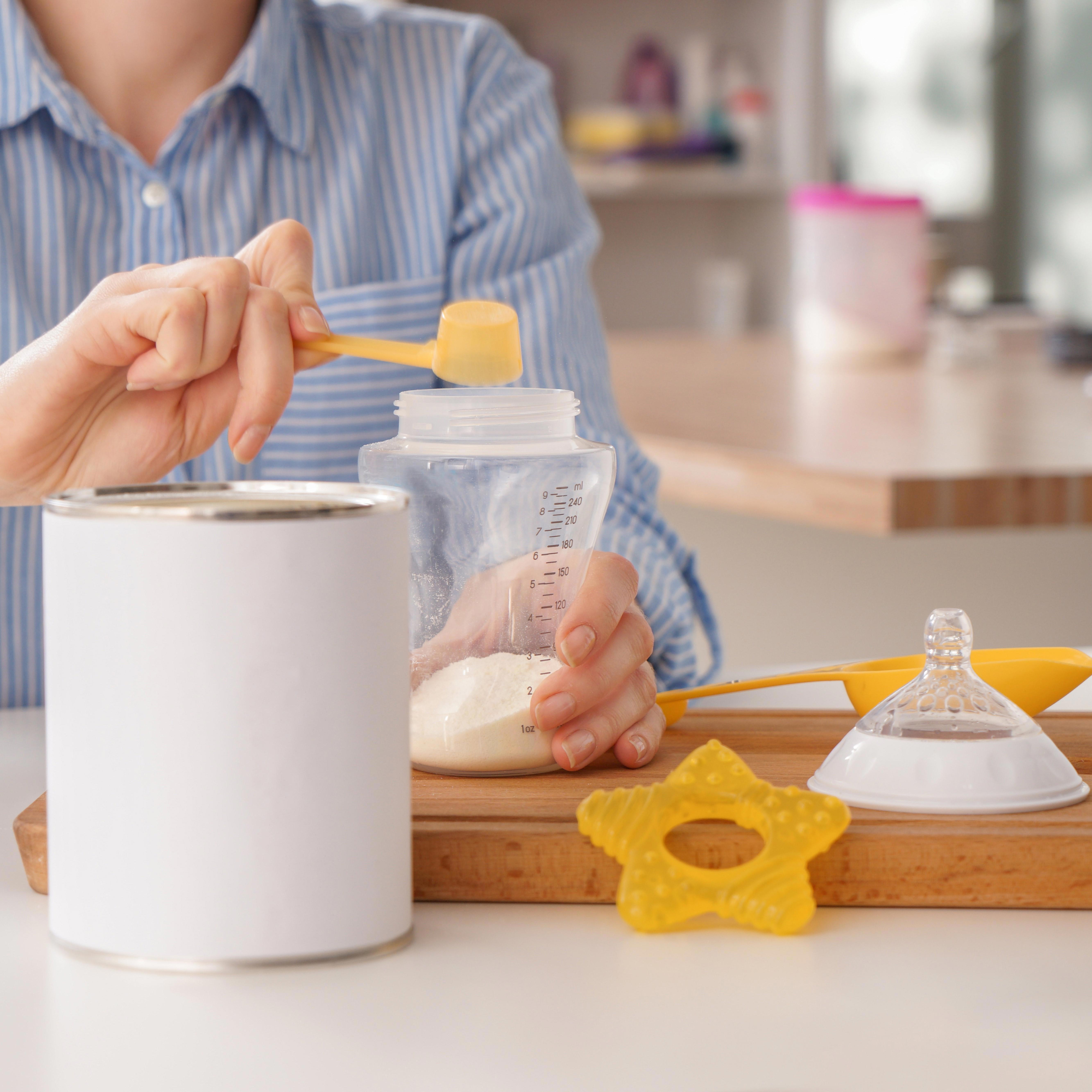 woman-preparing-baby-formula-at-table_zoom_1-1