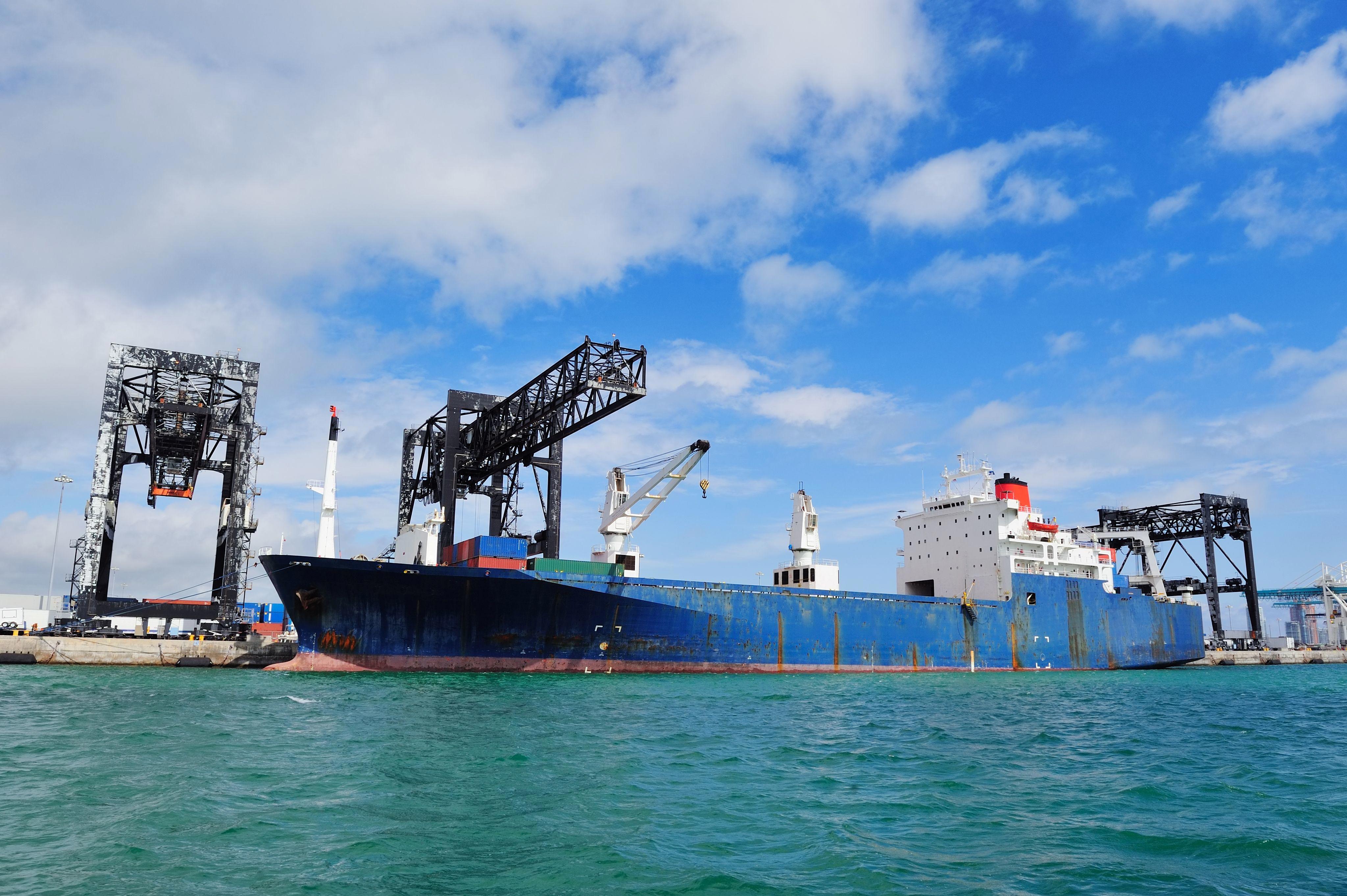 cargo-ship-miami-harbor-with-crane-blue-sky-sea