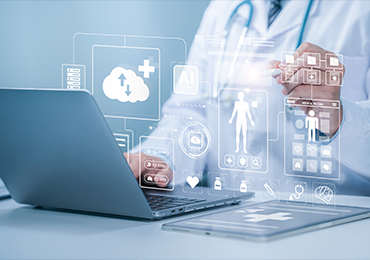Medical professional using a laptop, with holographic healthcare icons representing data analytics, AI, and medical records,illustrating MDS Consulting’s approach to post-marketing surveillance through advanced digital tools.