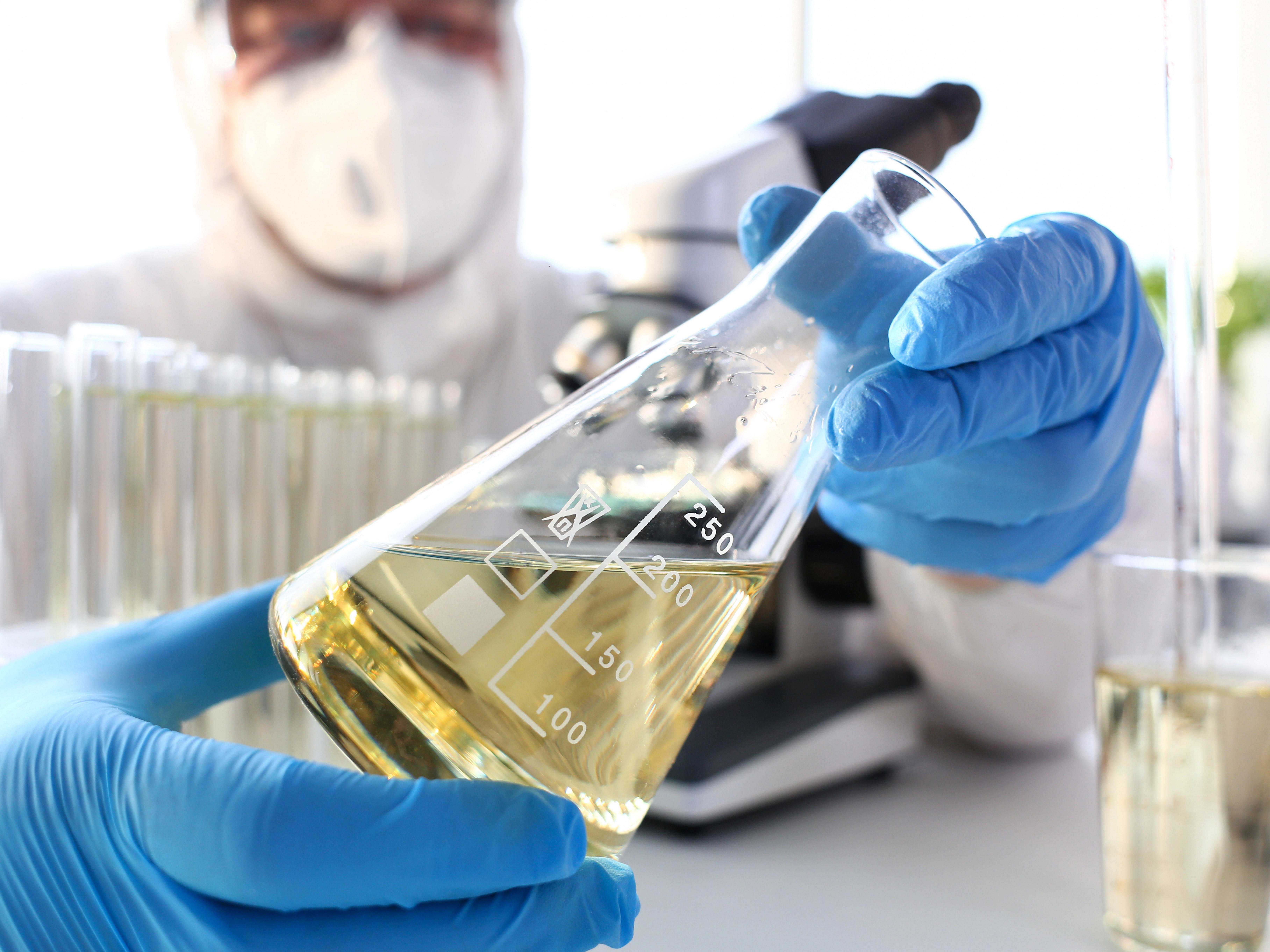 as_pharmaceuticals_4_scientist-arm-in-protective-gloves-hold-yellow-liquid-in-bottle-closeup_-8640-x-5760-px_4by3