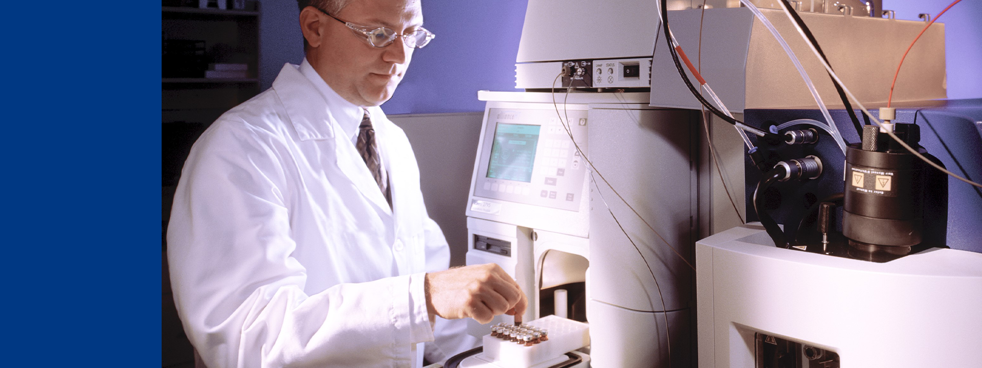 Scientist operating advanced analytical instrumentation to measure bioprocess residuals in a laboratory setting