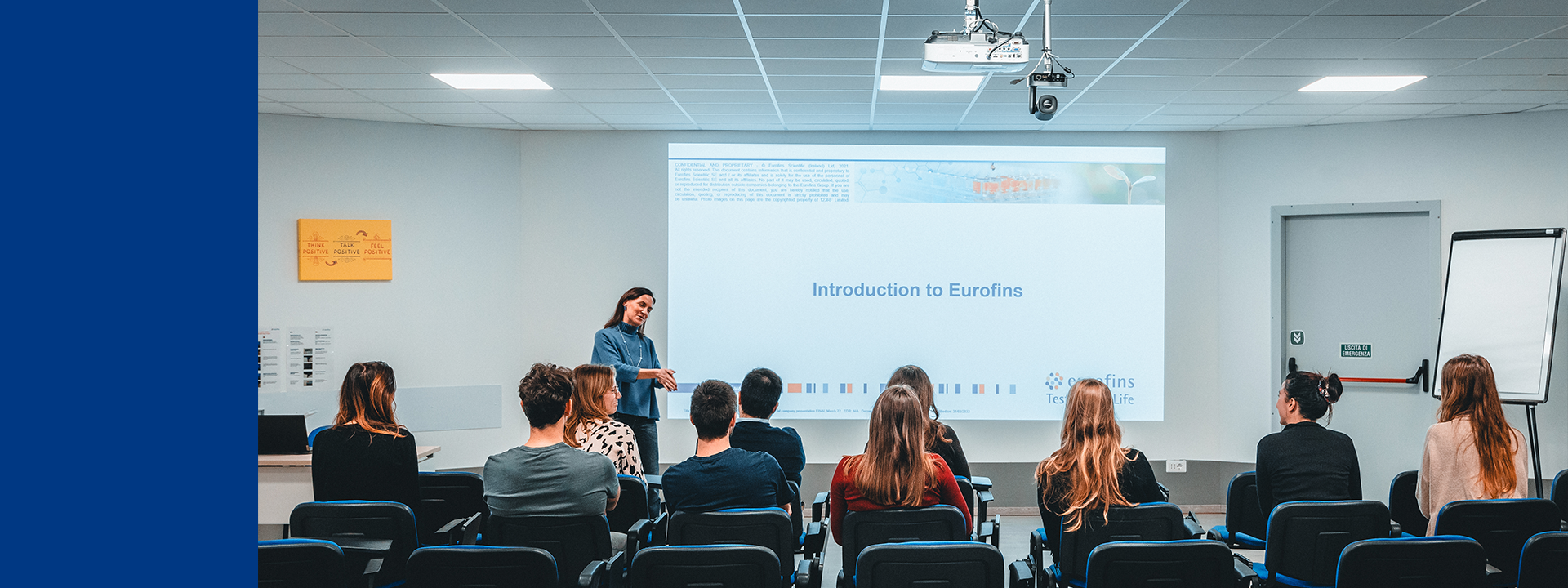 Group of participants seated in a modern classroom, viewing a presentation titled 'Introduction to Eurofins,' with a presenter gesturing toward the screen, illustrating MDS Consulting’s tailored training and seminars for medical device professionals