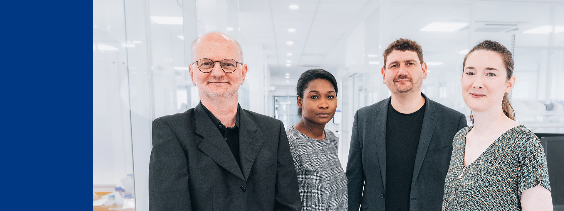 Four members of the MDS Consulting team in a bright, modern office setting, standing near desks and equipment, symbolising collaboration in clinical evaluation activities.