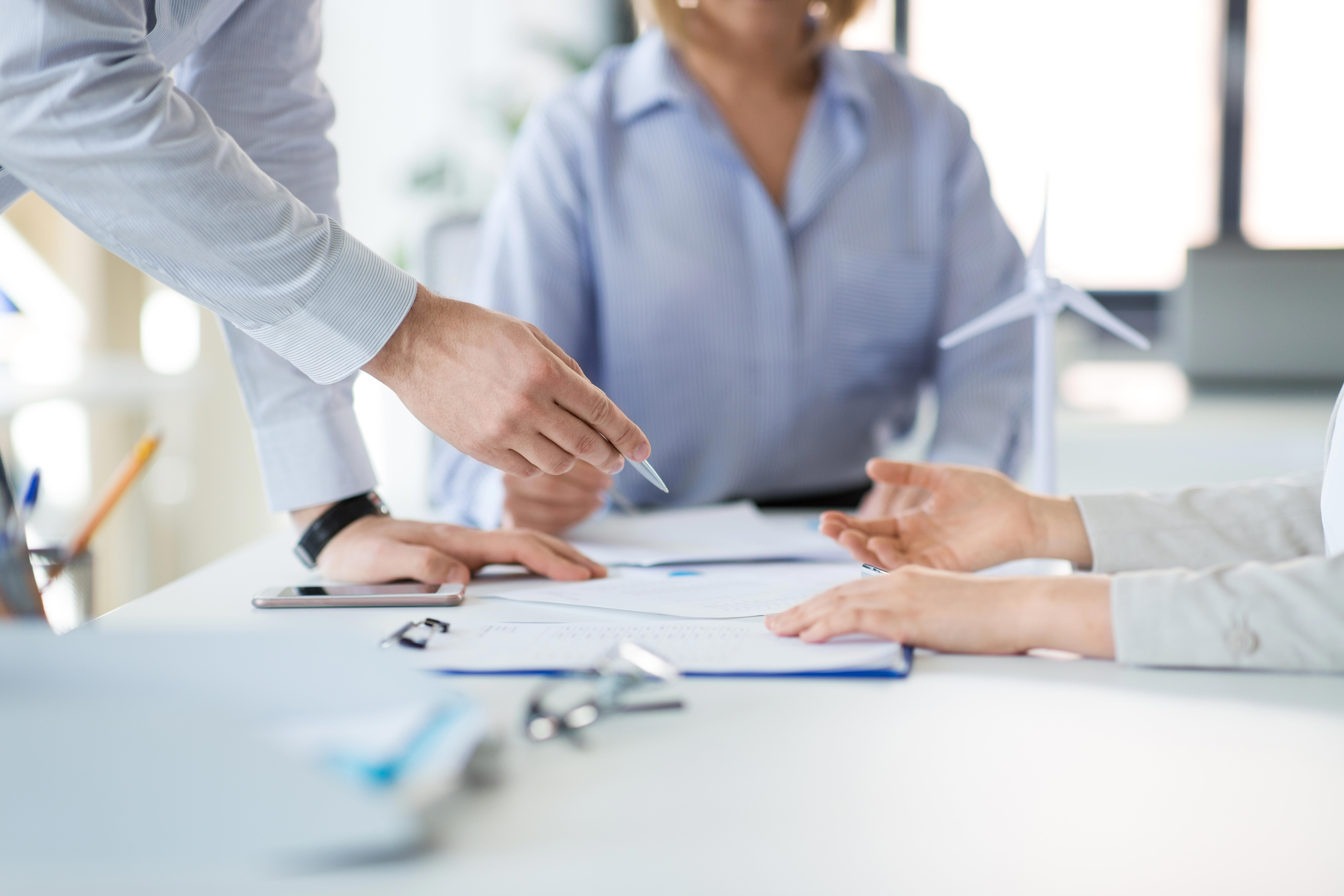 business-team-discussing-papers-at-office_8640-x-5760px
