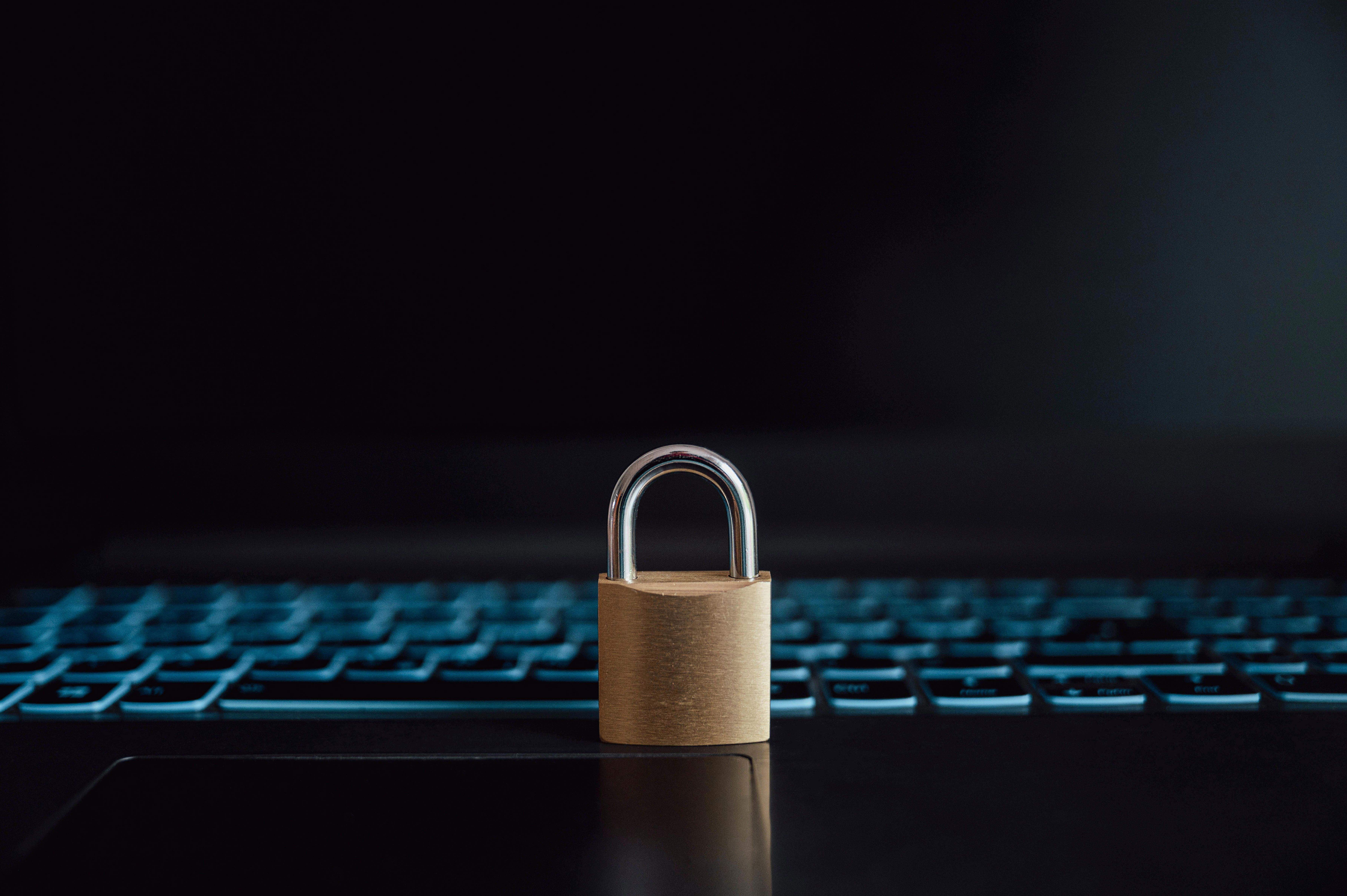 golden-padlock-placed-on-an-open-black-laptop-computer_7141-x-4750-px