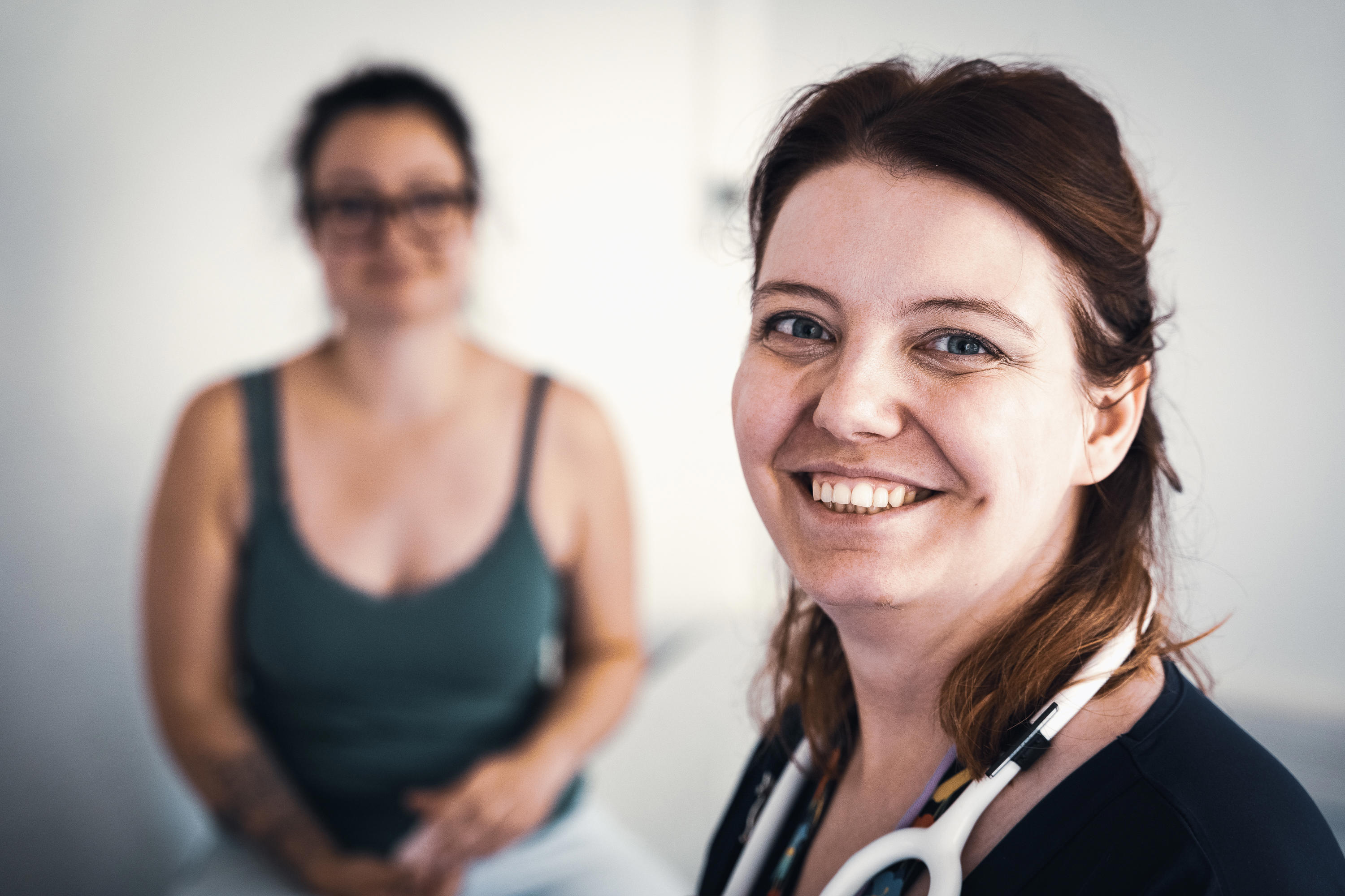 doctor-lila-krebs-drouot-smiling-with-a-patient-in-the-background