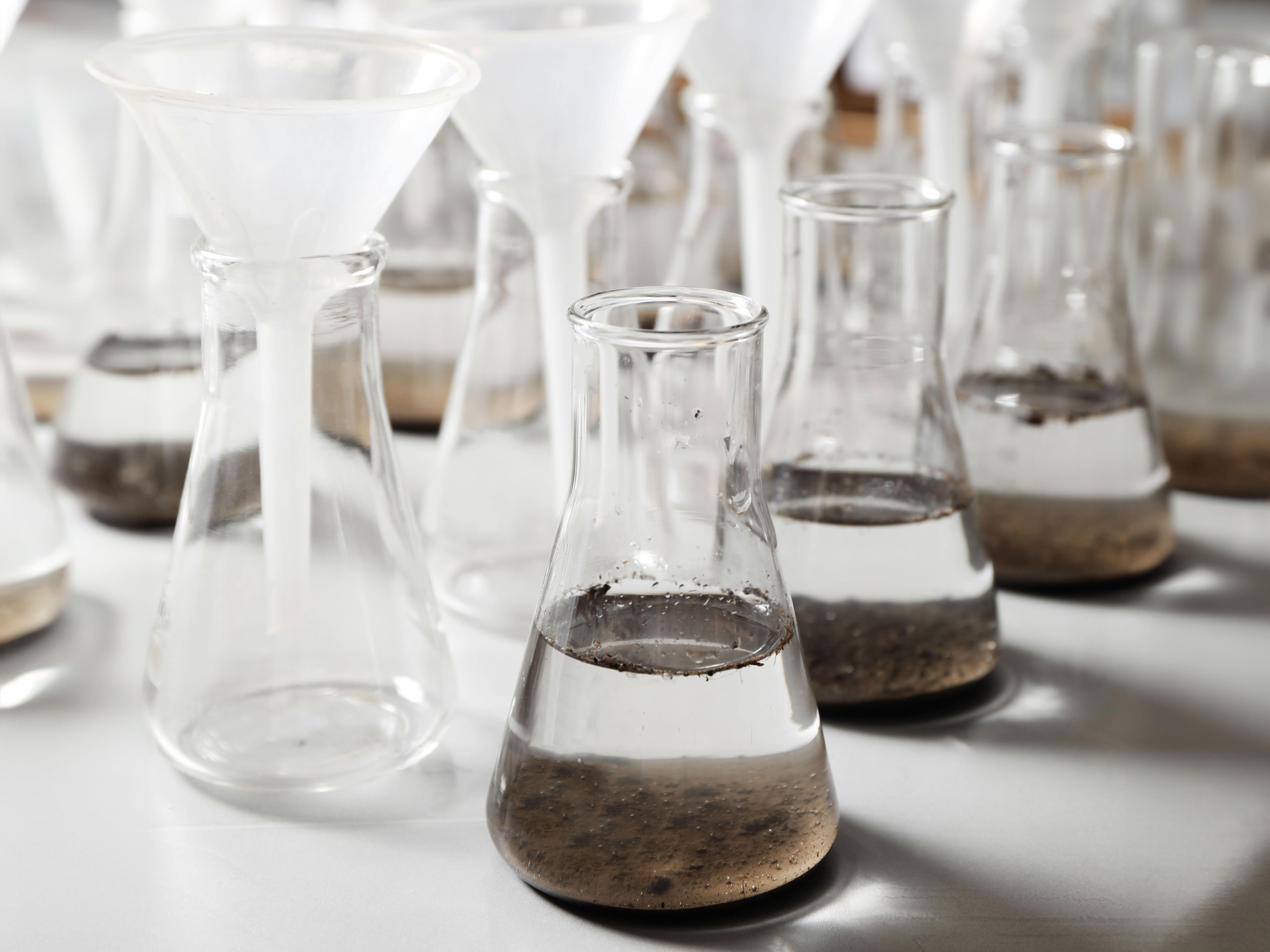 4by3_laboratory-glassware-with-soil-extracts-and-funnels-on-table_6720-x-10080-px