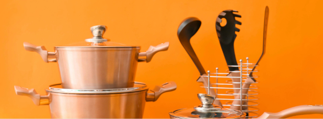 copper-kitchen-utensils-and-raw-food-on-table-against-orange-background_8640-x-5760-px1