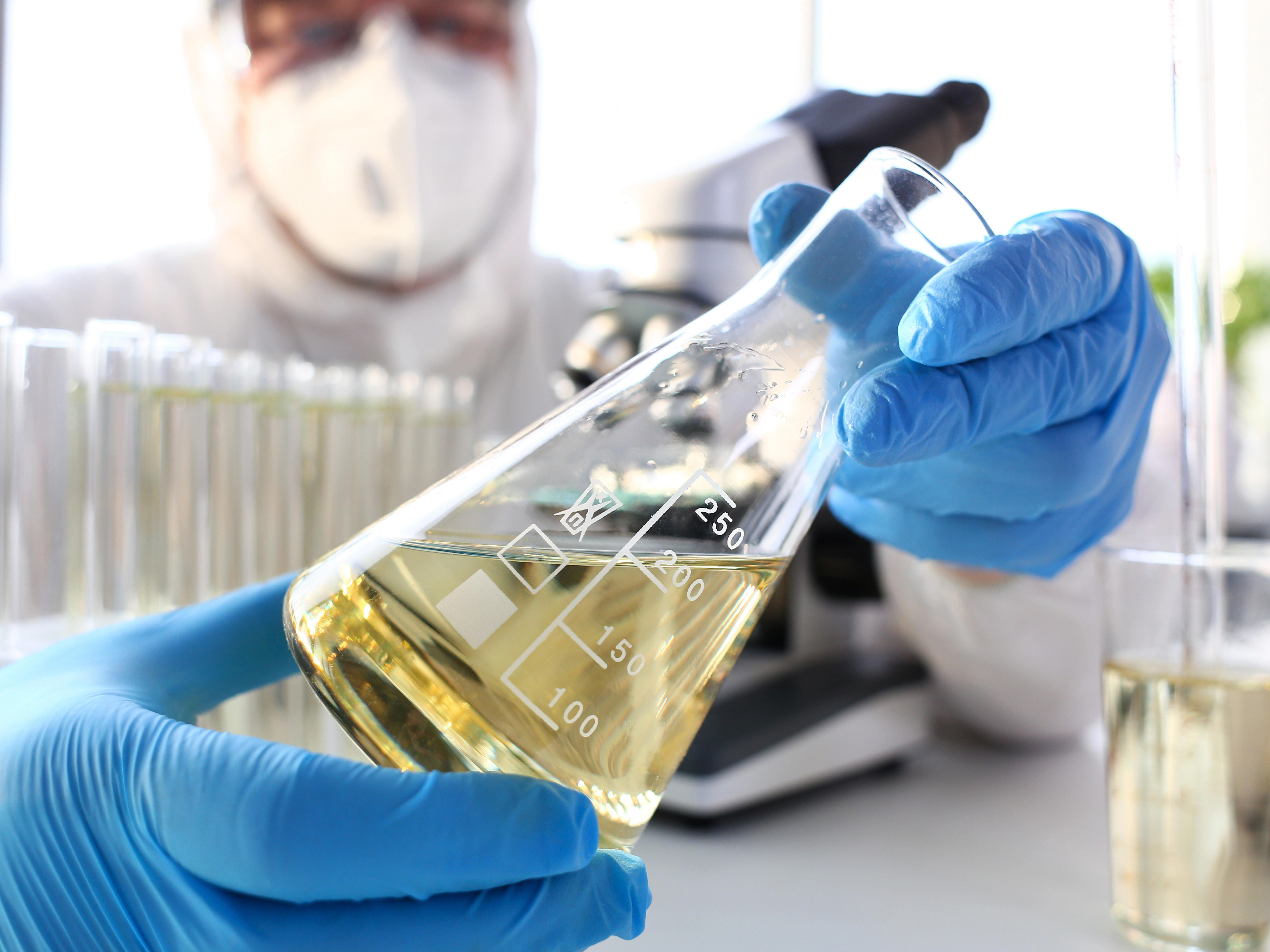 as_chemicals_6_scientist-arm-in-protective-gloves-hold-yellow-liquid-in-bottle-closeup_-8640-x-5760-px_4by3
