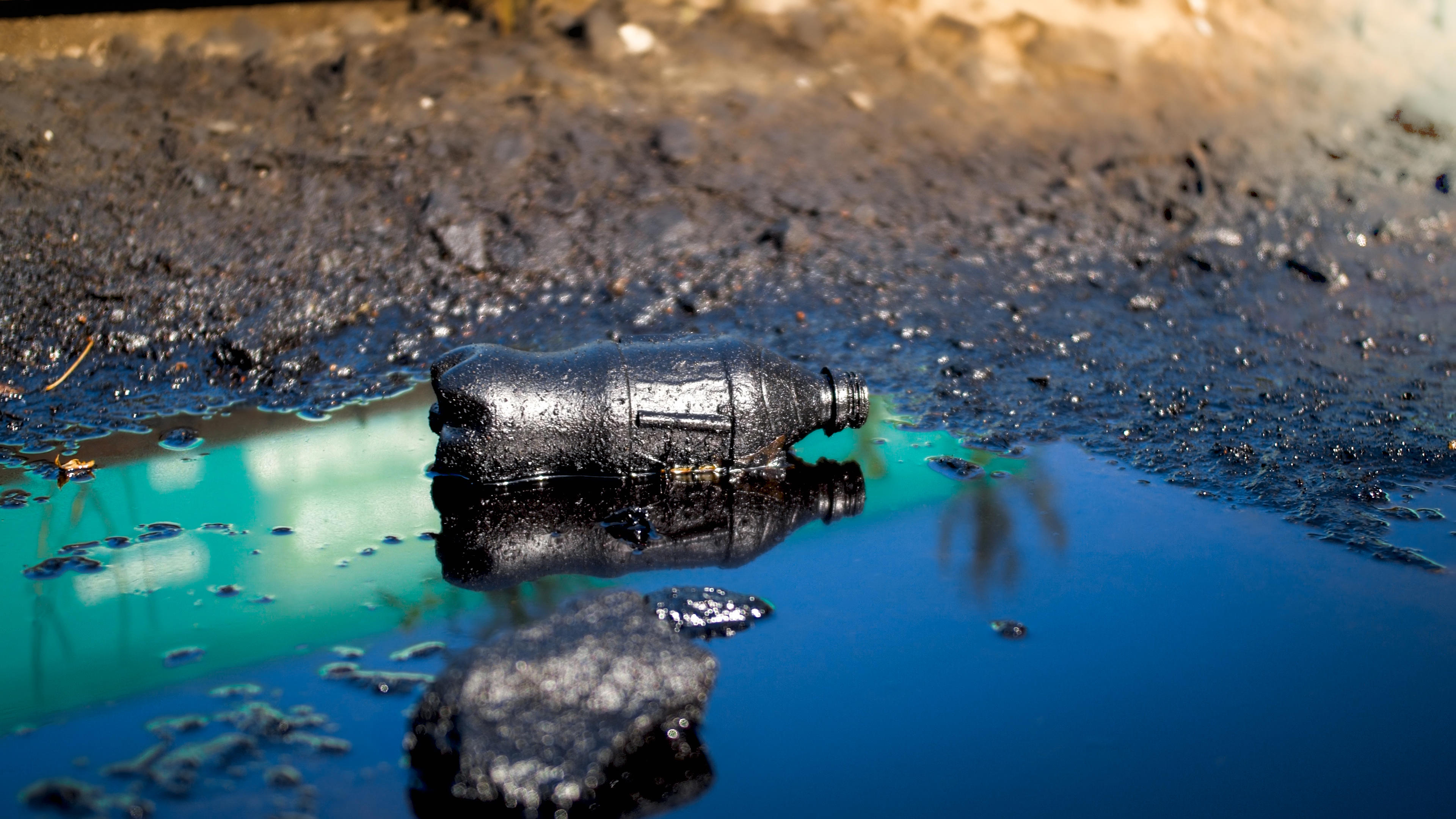 plastic-bottle-polluting-water-with-tar-and-grime-2026-01-06-10-17-09-utc