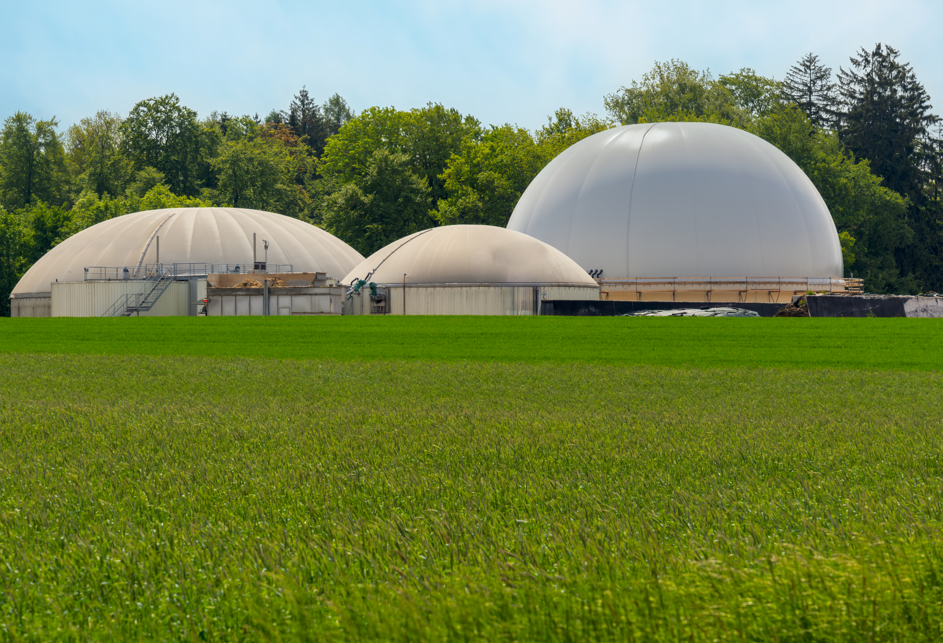 biogas-plant-domes-in-green-field-scenery-2026-01-07-01-55-26-utc