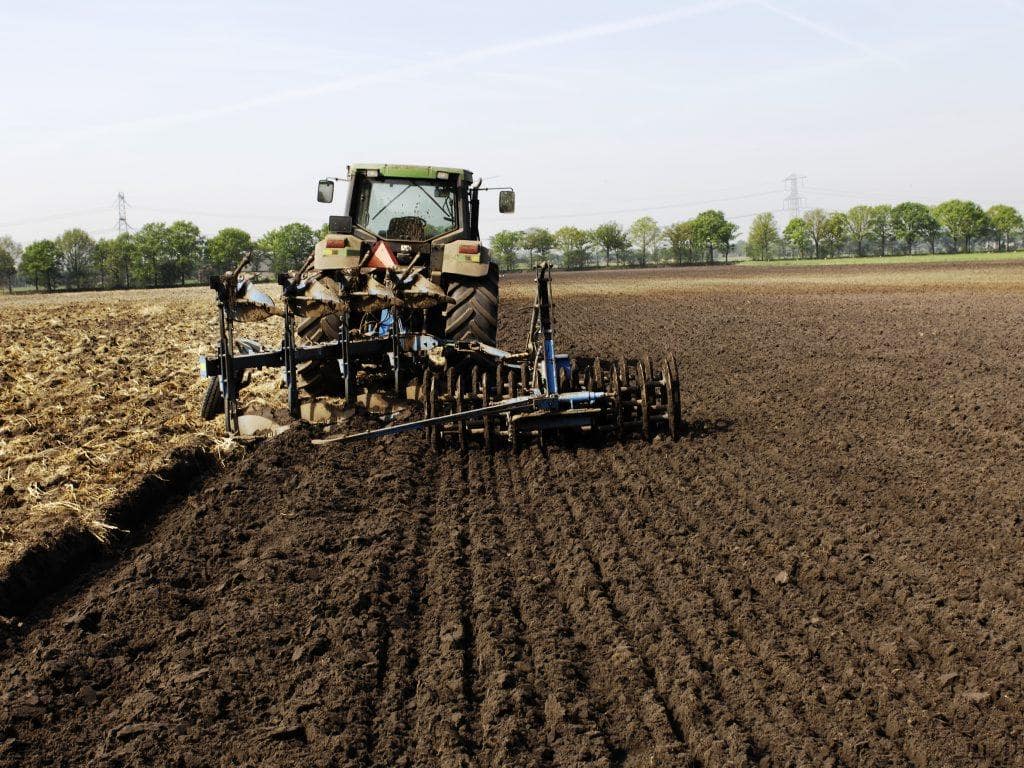 agro-tractor-ploughinh-soil-field-preparing