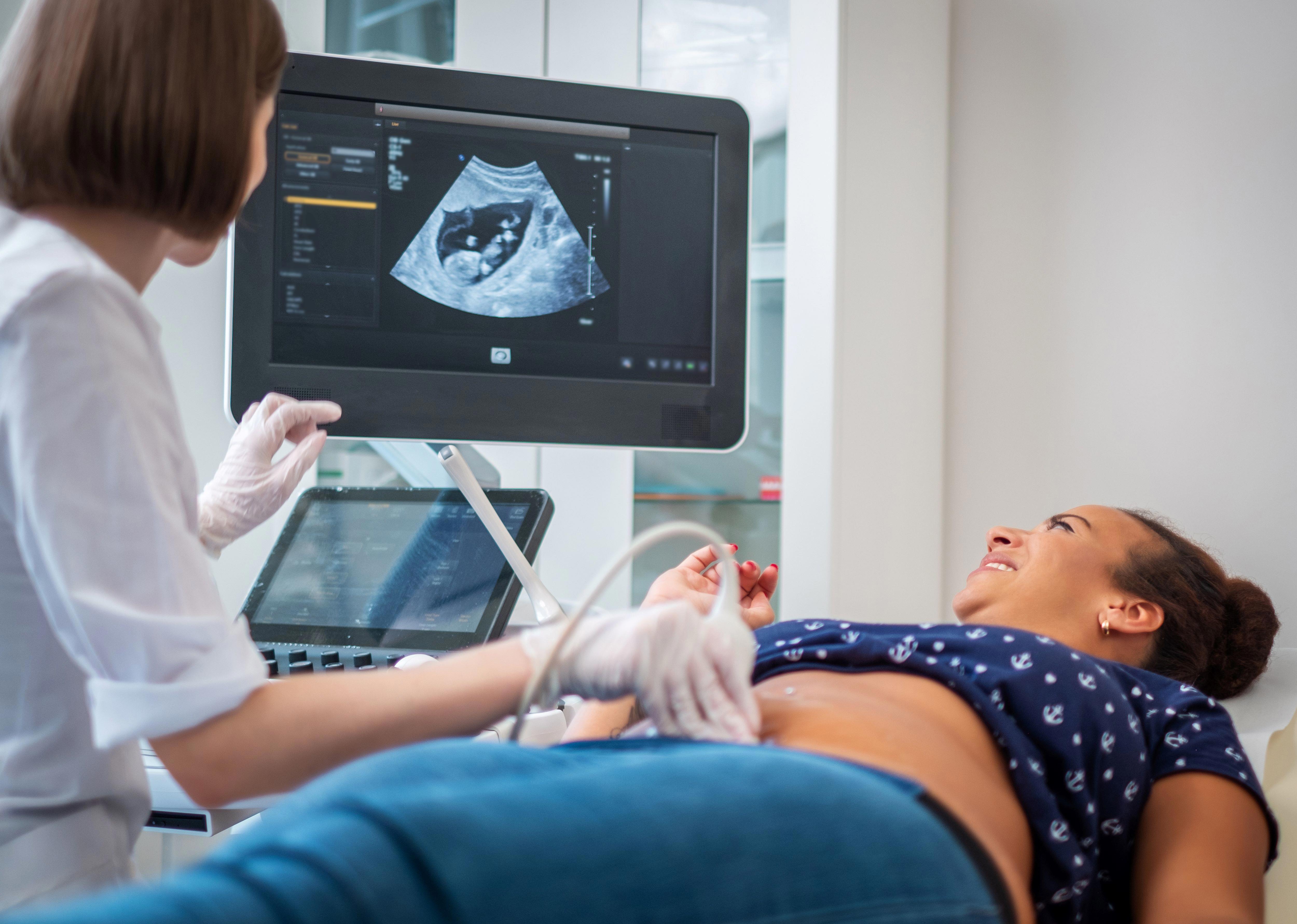 pregnant-woman-on-utltrasonographic-examination-at-hospital_7995-x-5698px