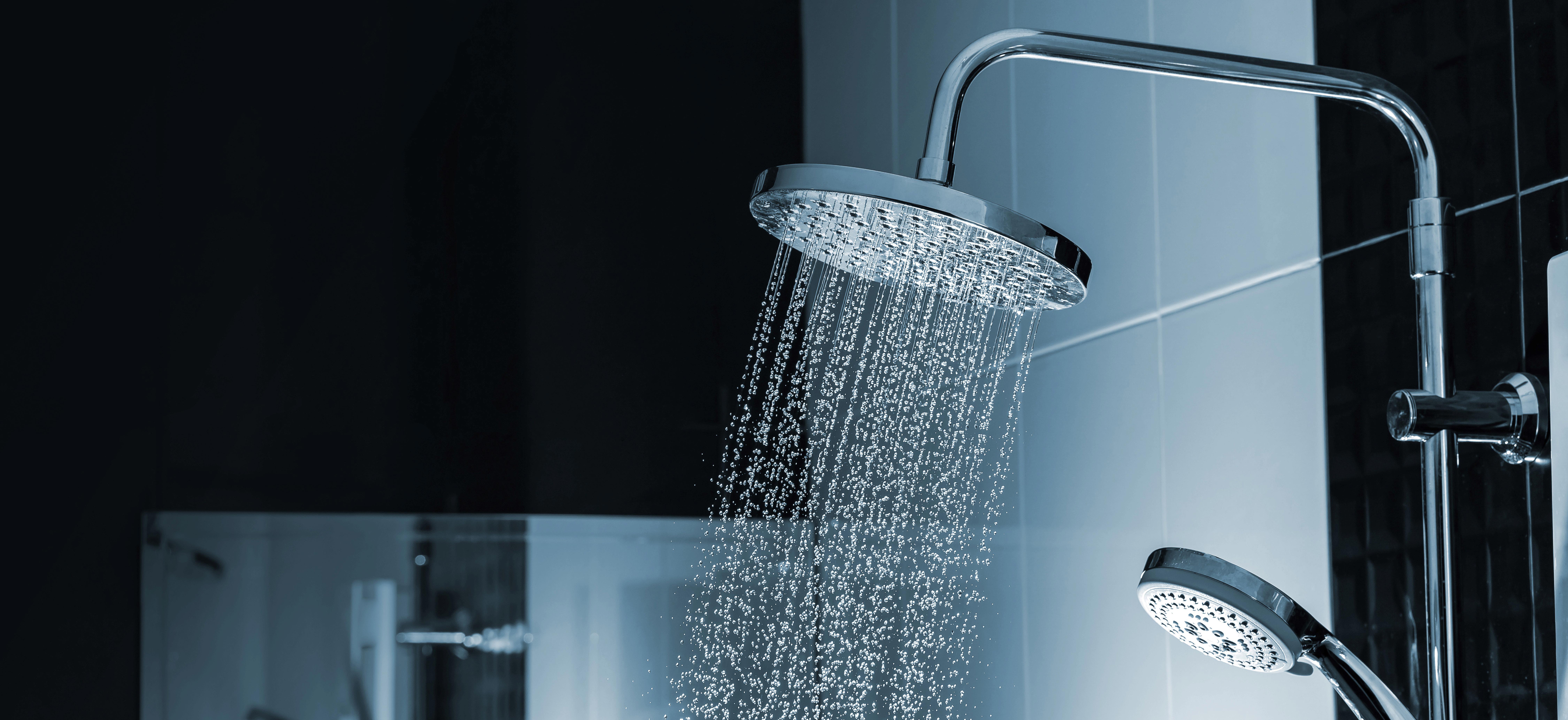 close-up-of-water-flowing-from-shower-in-the-bathroom-interior_9000-x-4132-px