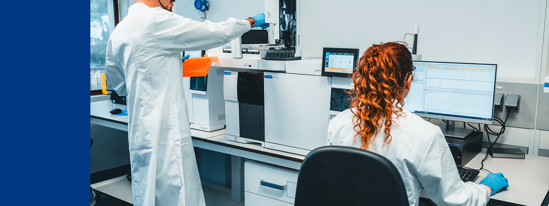 Techniciens de laboratoire pharmaceutique réalisant des tests comparatifs de produits à l’aide d’équipements analytiques et informatiques, illustrant l’expertise en validation de nettoyage, contrôle qualité, conformité GMP et prévention de la contamination croisée dans un environnement stérile conforme aux BPF.