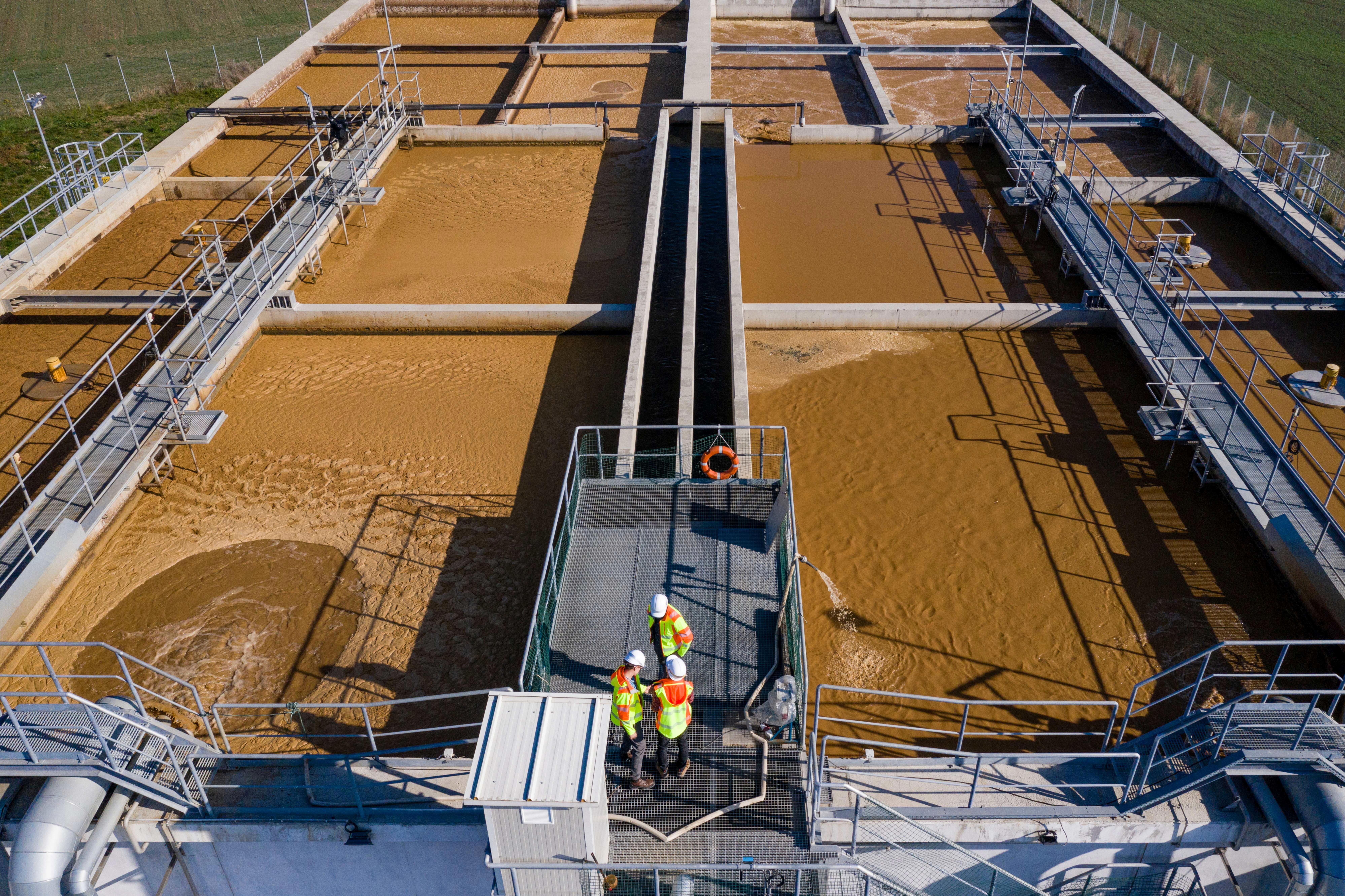 engineers-assesing-waste-water-treatment-plant-from-platform_7989x5322-pxl