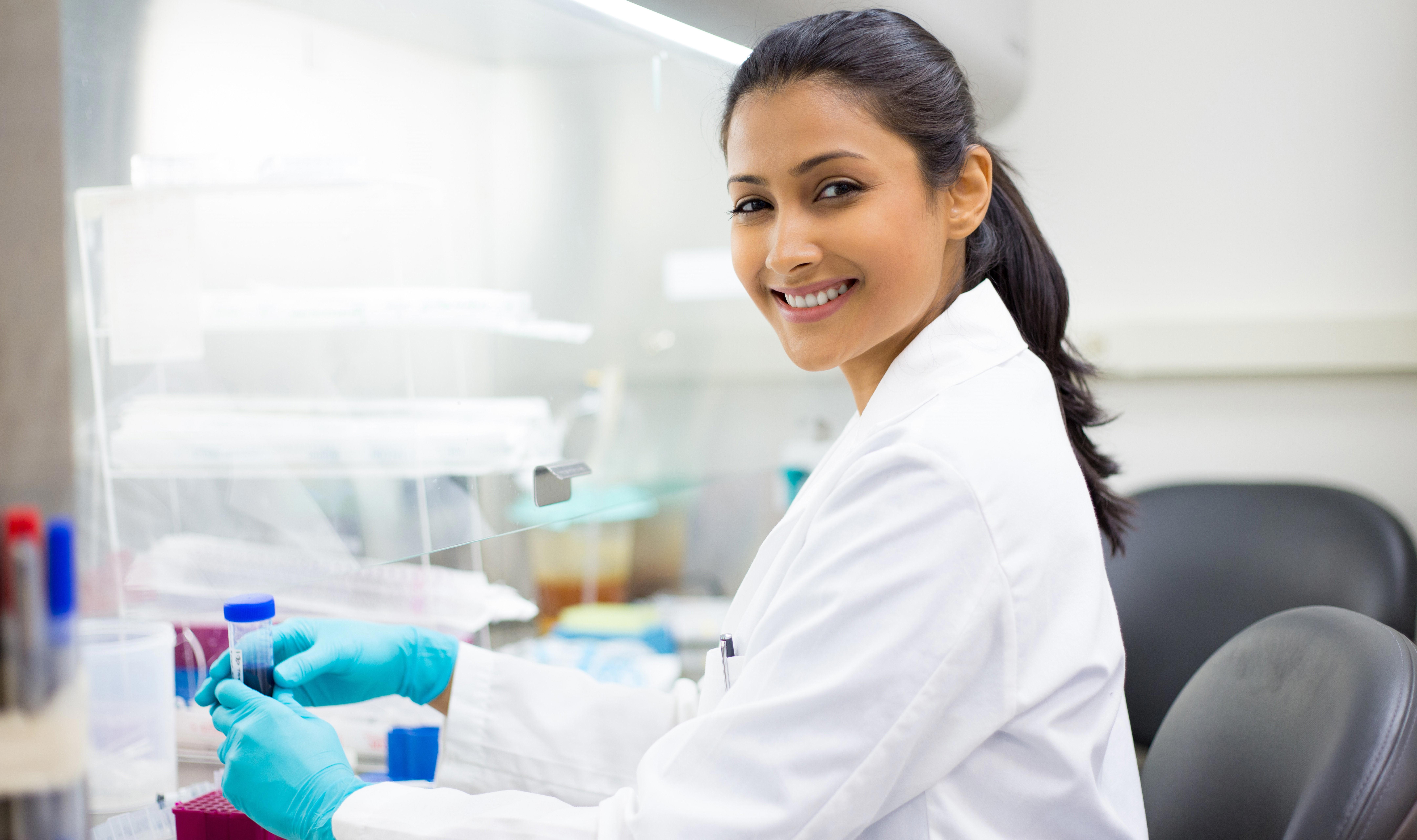 closeup-portrait-scientist-holding-50-ml-conical-tube-with-blue-liquid-solution-laboratory-experiments-_8640-x-5760-px-narrow