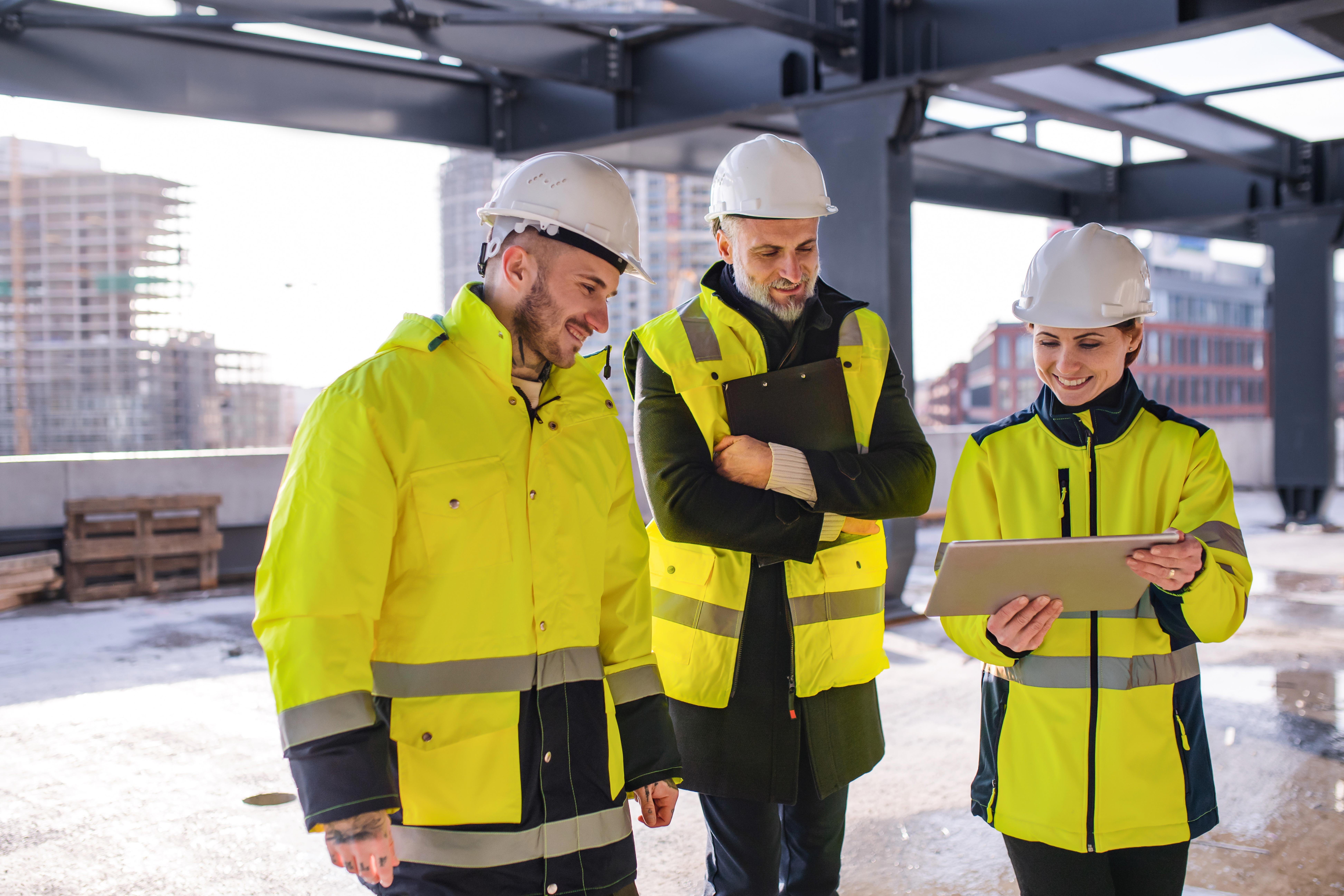 group-of-engineers-standing-outdoors-on-construction-site-using-tablet_7783-x-5190-px