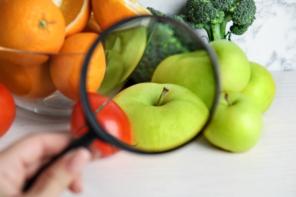woman-with-magnifying-glass-exploring-vegetables-and-fruits-closeup_10080-x-6720px