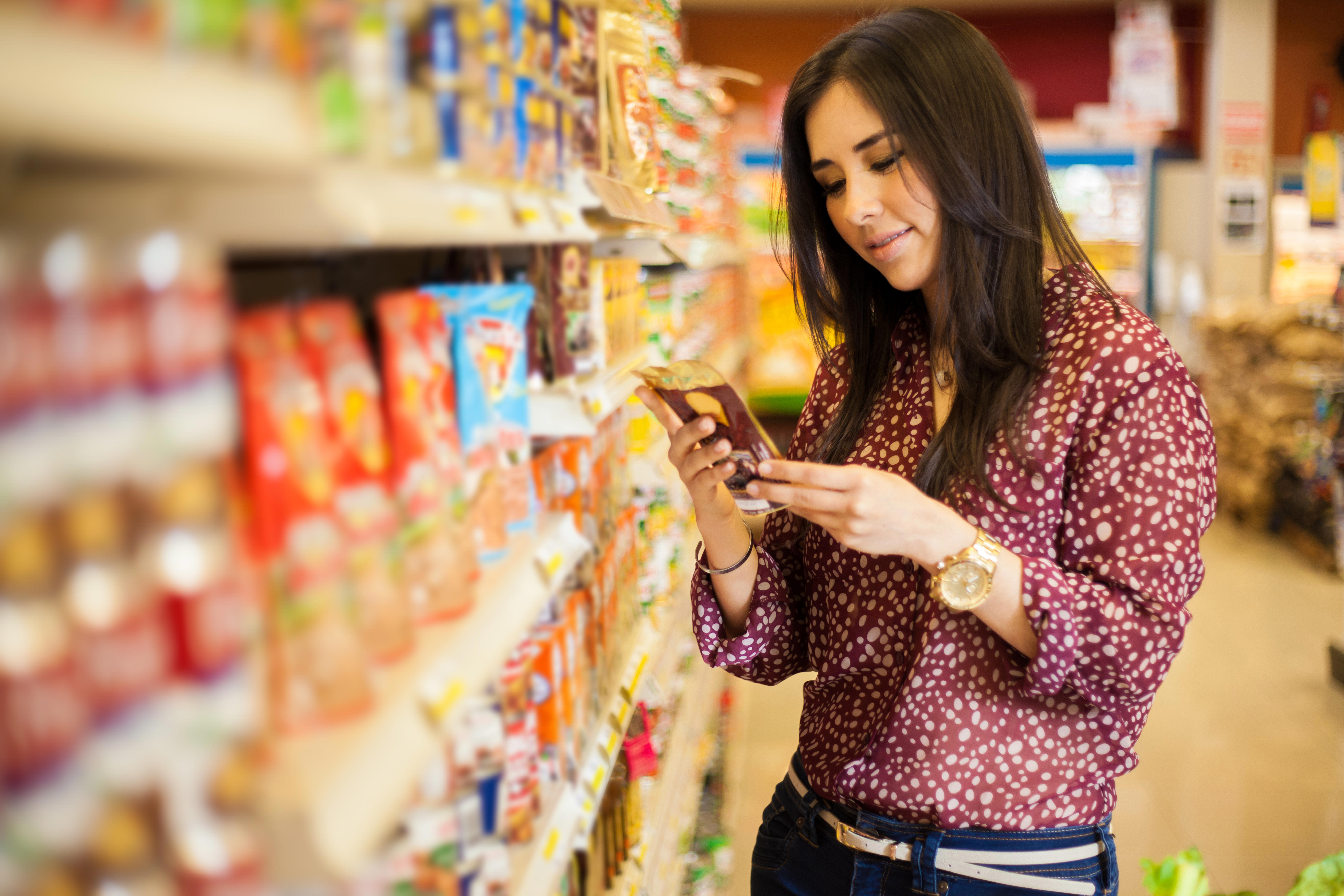 cute-young-woman-examining-a-product-label-while-shopping-at-the-store_8007-x-5338-px-2