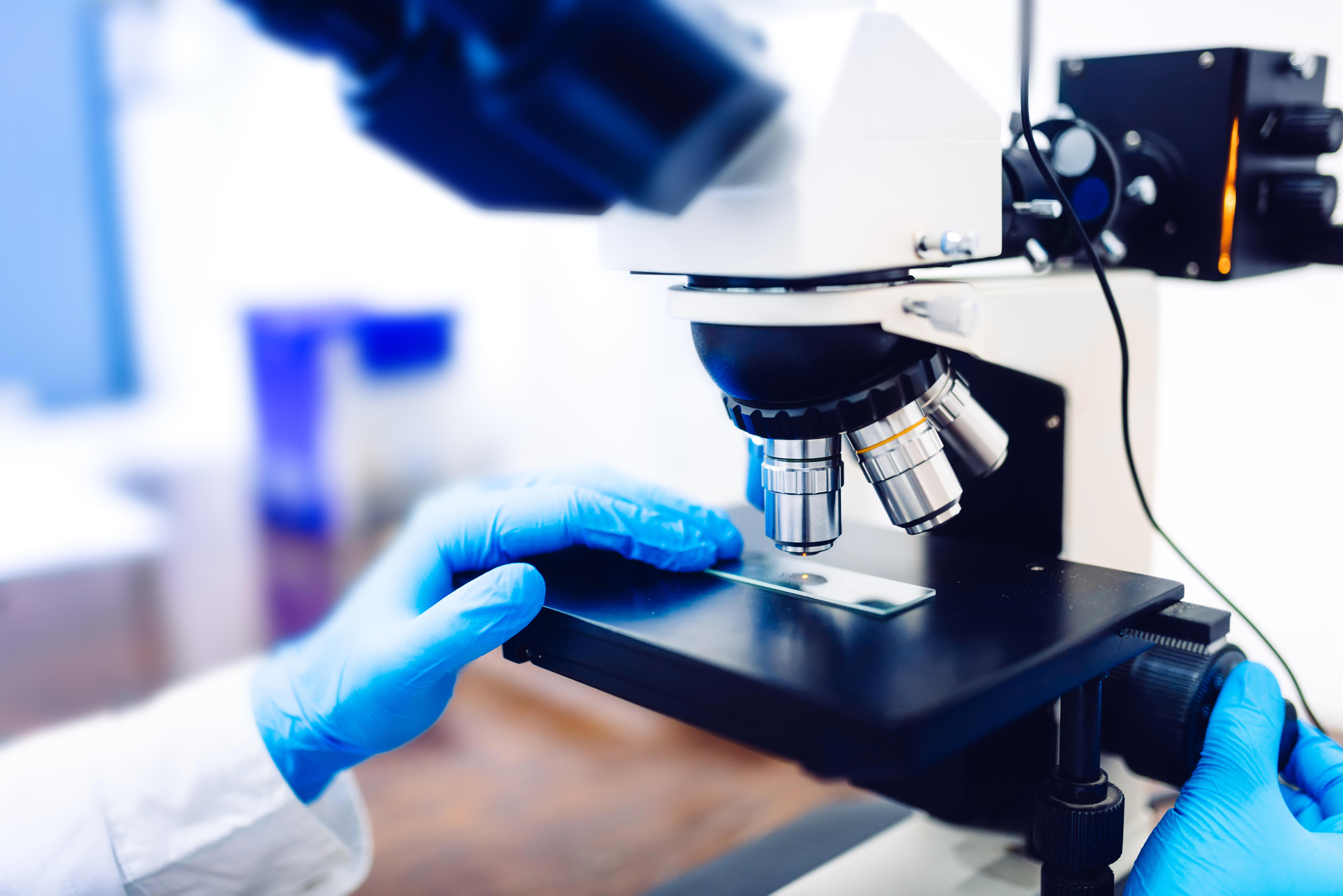 scientist-hands-using-microscope_9024-x-6024-px