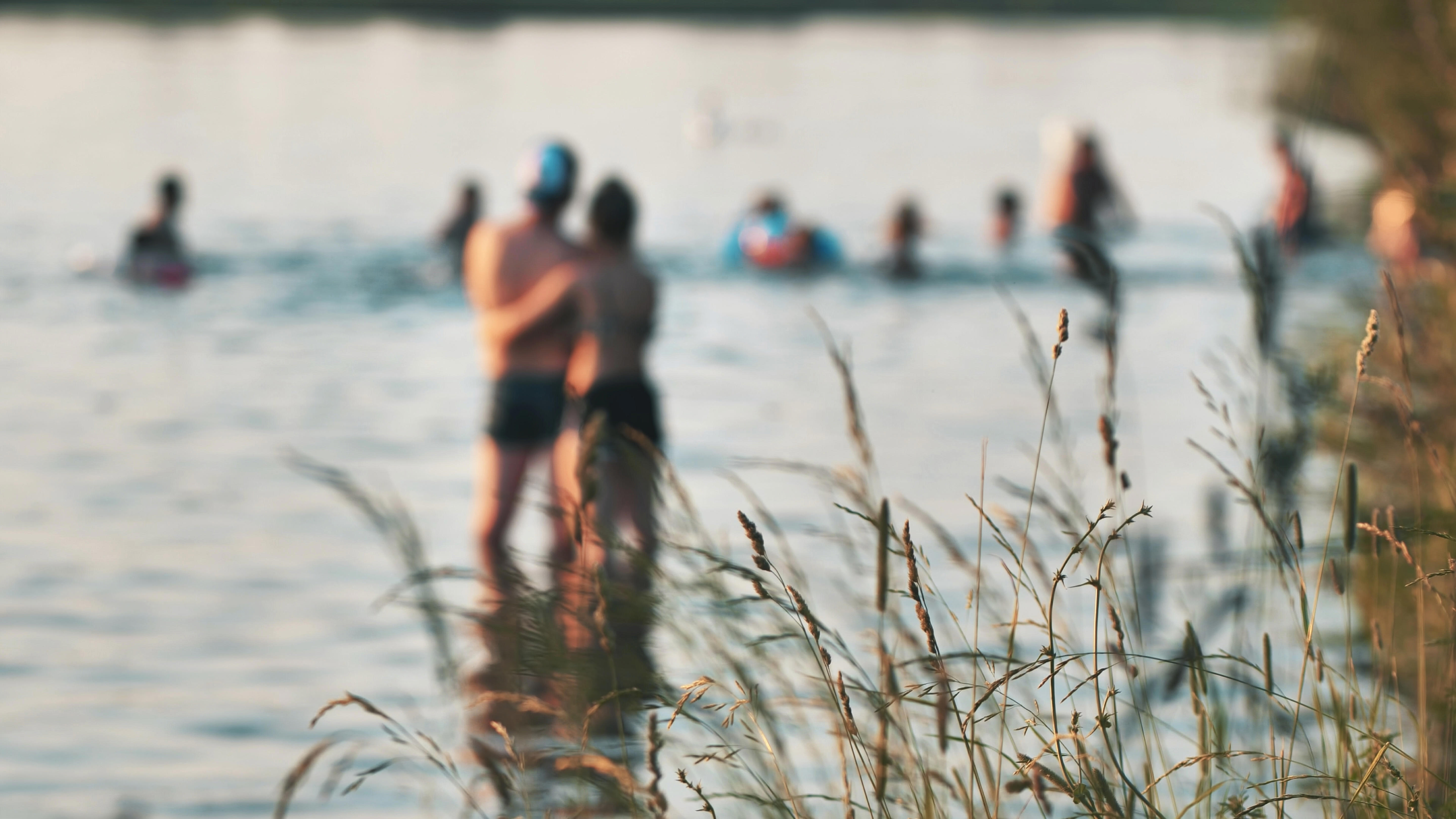 swimming-people-on-the-city-lake-and-against-the-background-of-the-grass_5760-x-3240px