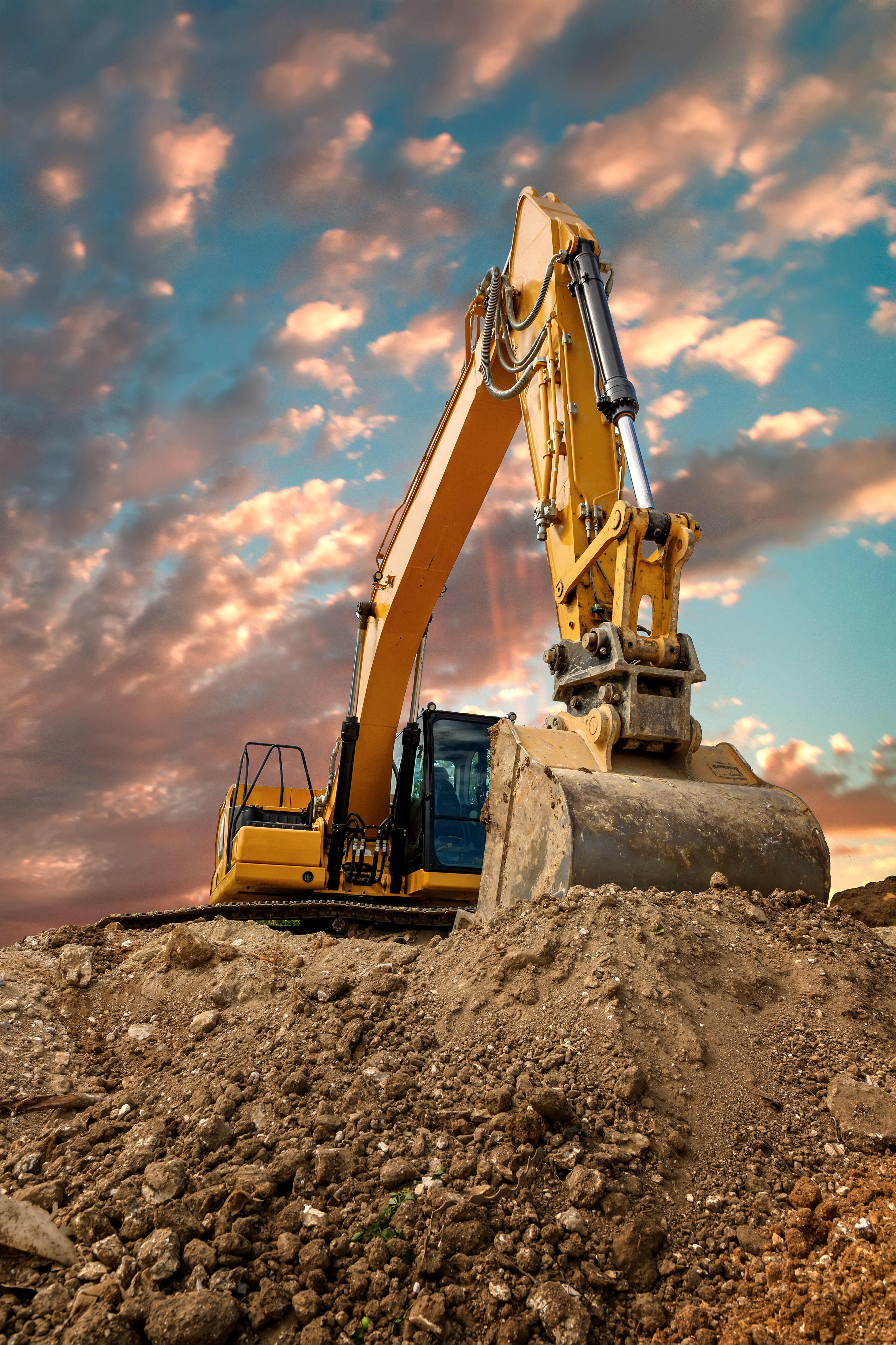 crawler-excavator-during-earthmoving-works-on-construction-site-at-sunset_4500-x-6750-px_compressed (2)