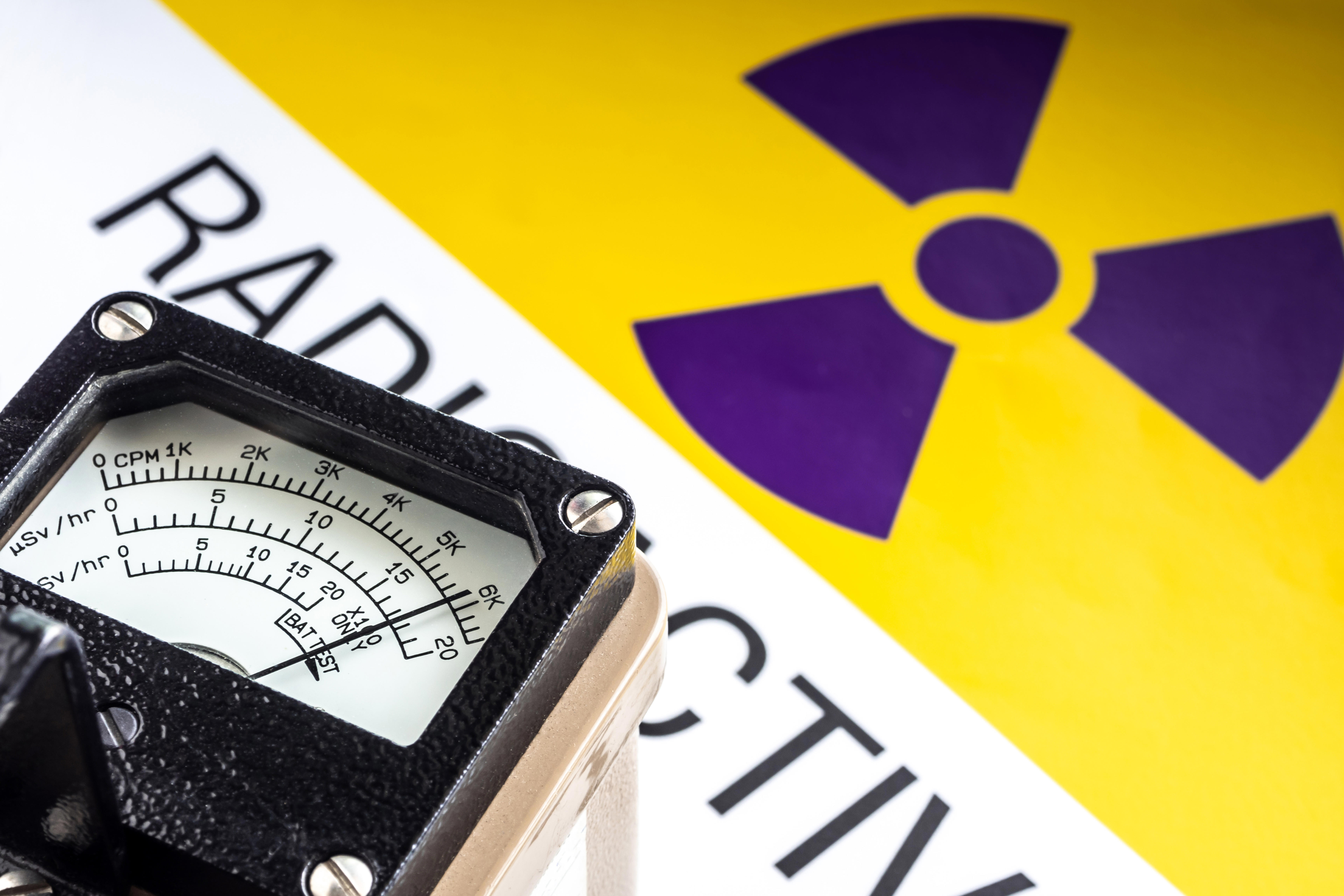 hand-held-radiation-survey-instrument-detecting-at-the-radioactive-material-symbol-on-label_6912-x-4608px
