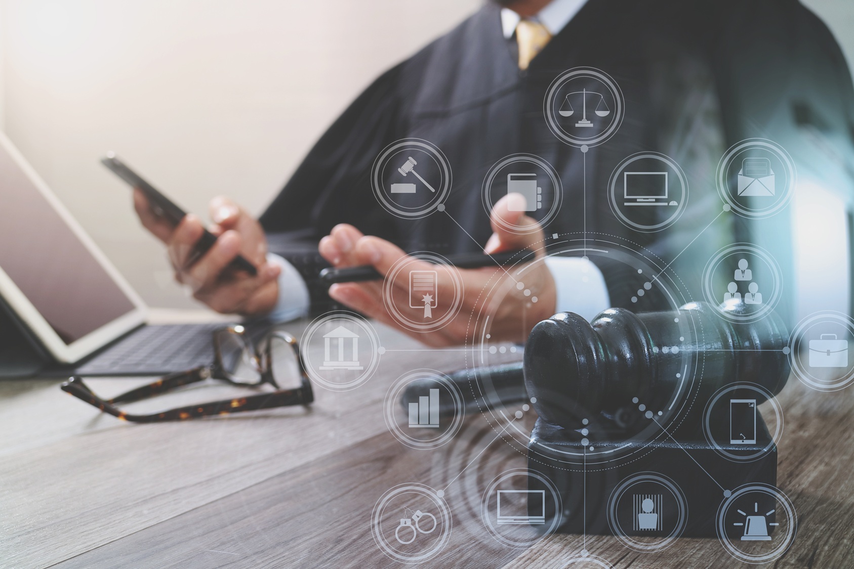 male-judge-in-a-courtroom-with-the-gavel-working-with-smart-phone-digital-tablet-computer-docking_9000-x-6000-px