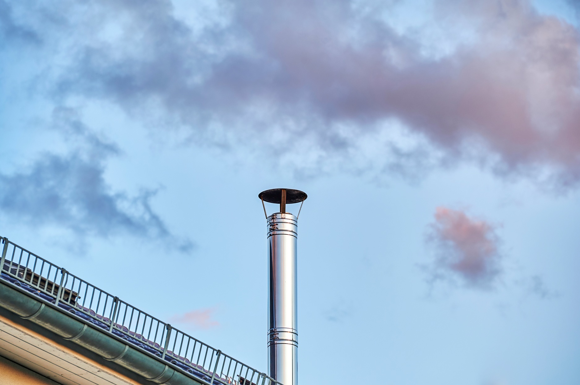 a-stainless-steel-chimney-and-parts-of-a-roof-at-dusk_7500-x-4990-px