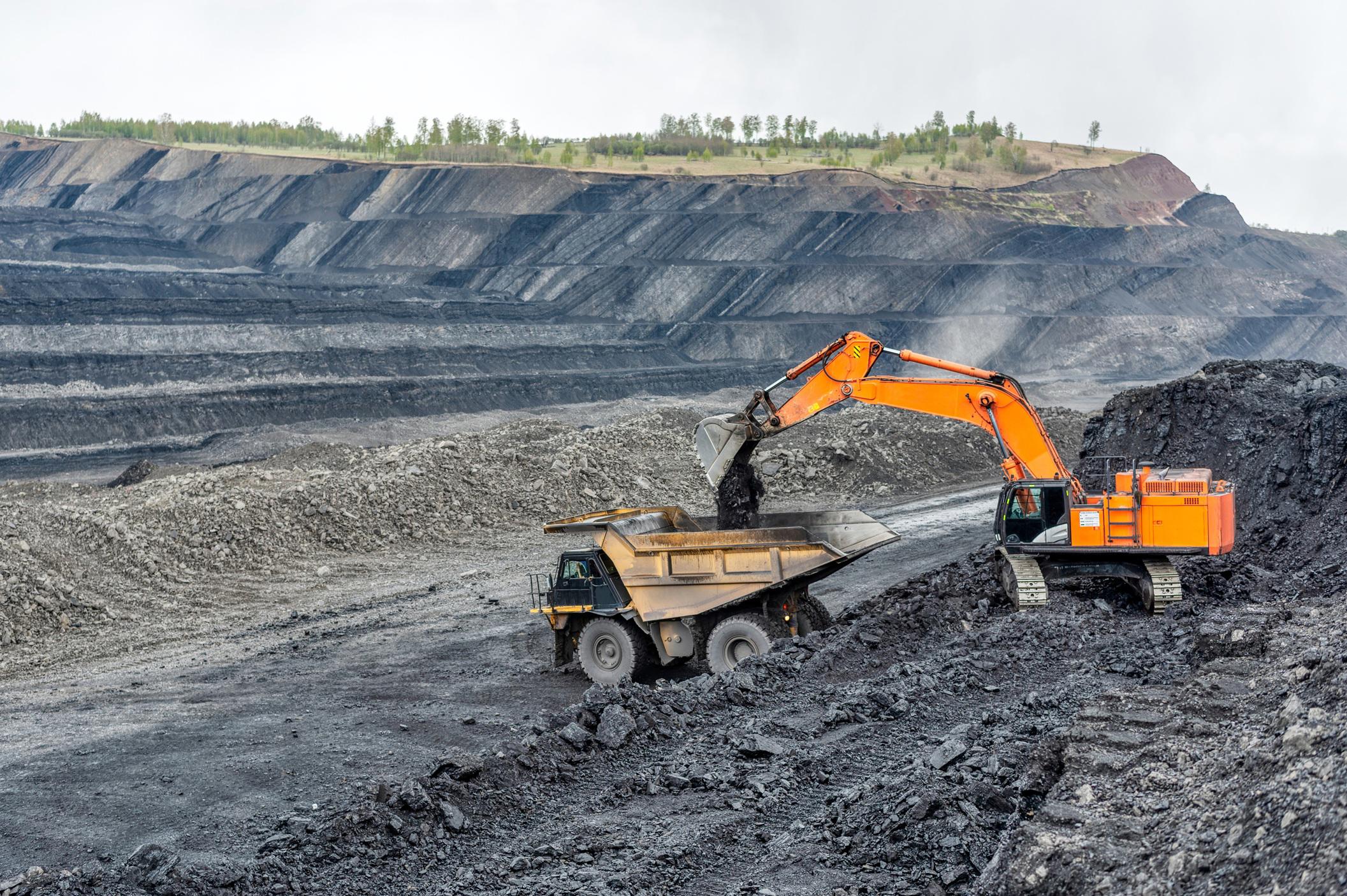 coal-mining-in-a-quarry-a-hydraulic-excavator-loads-a-dump-truck_8455-x-5626-px