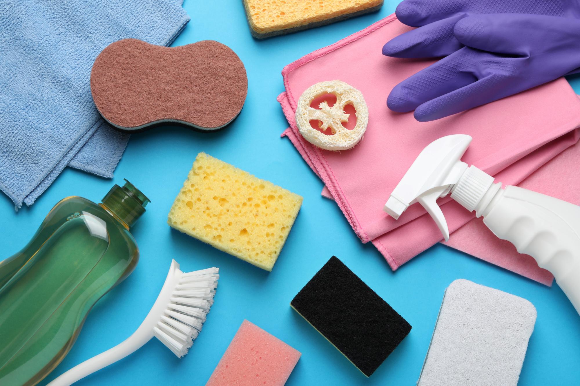 many-different-sponges-and-other-cleaning-products-on-light-blue-background-flat-lay_-10080-x-6720-px