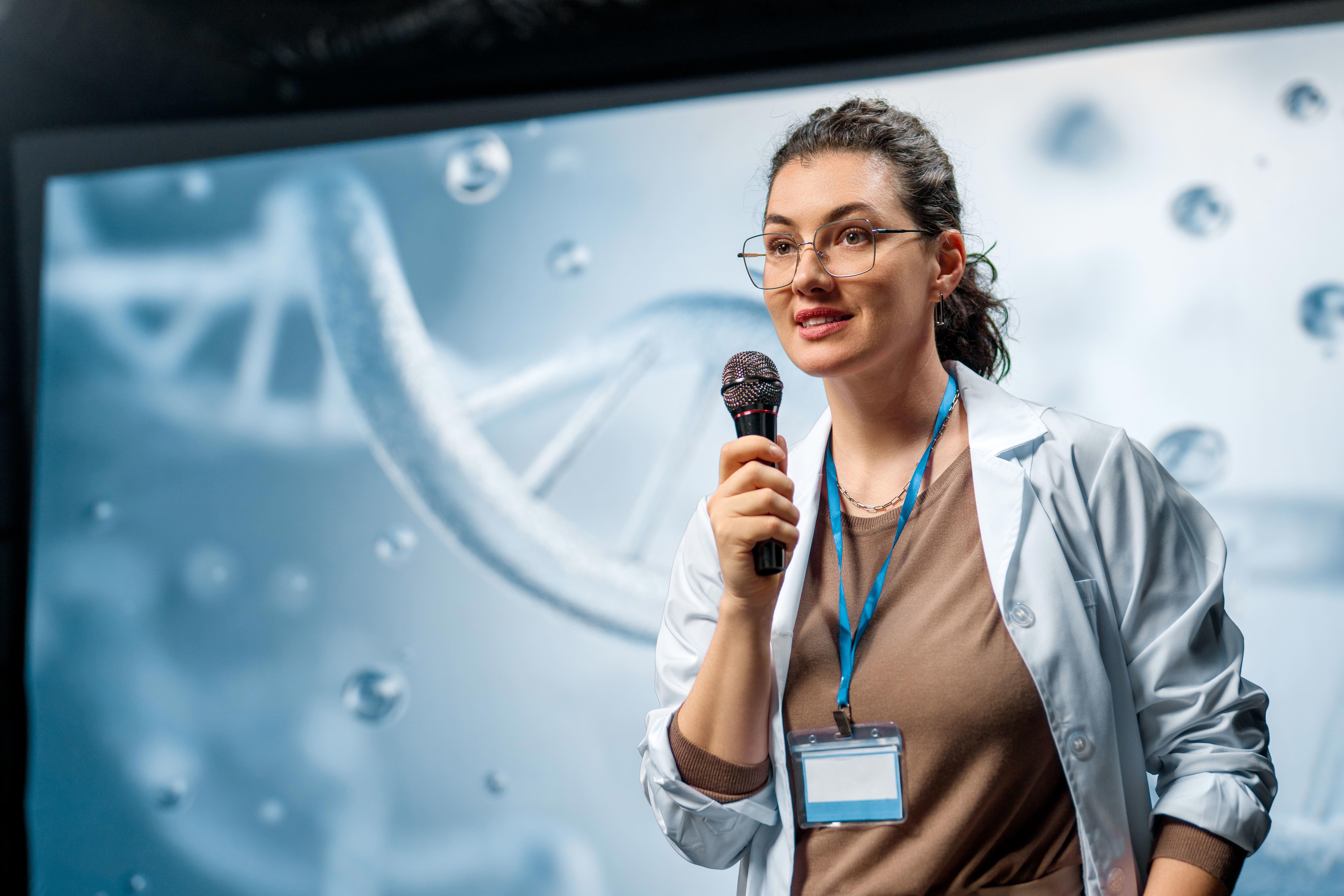a-woman-is-giving-a-presentation-at-a-conference-on-care-products_8250-x-5500px-1