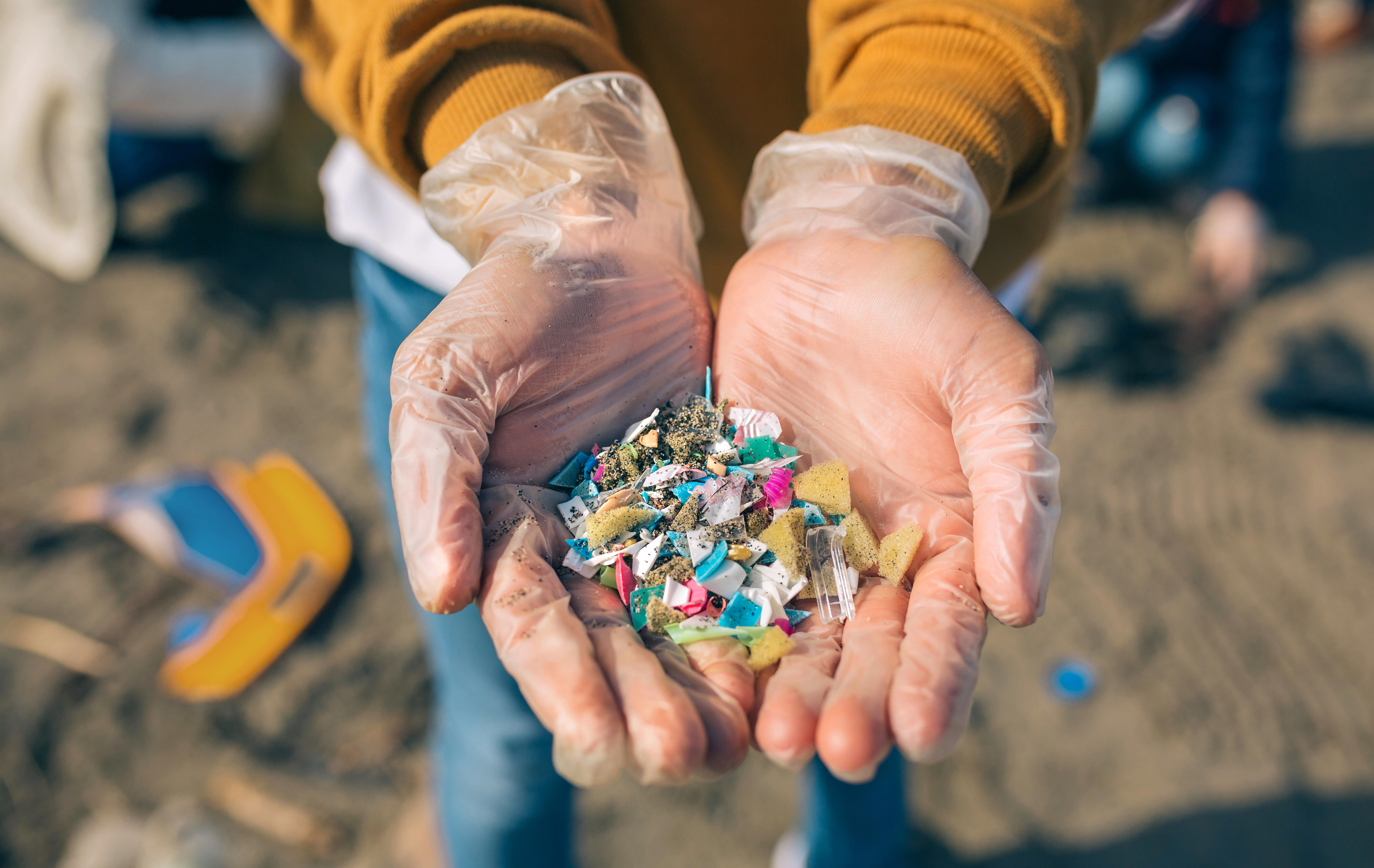 detail-of-hands-showing-microplastics-on-the-beach_8640-x-5460-px