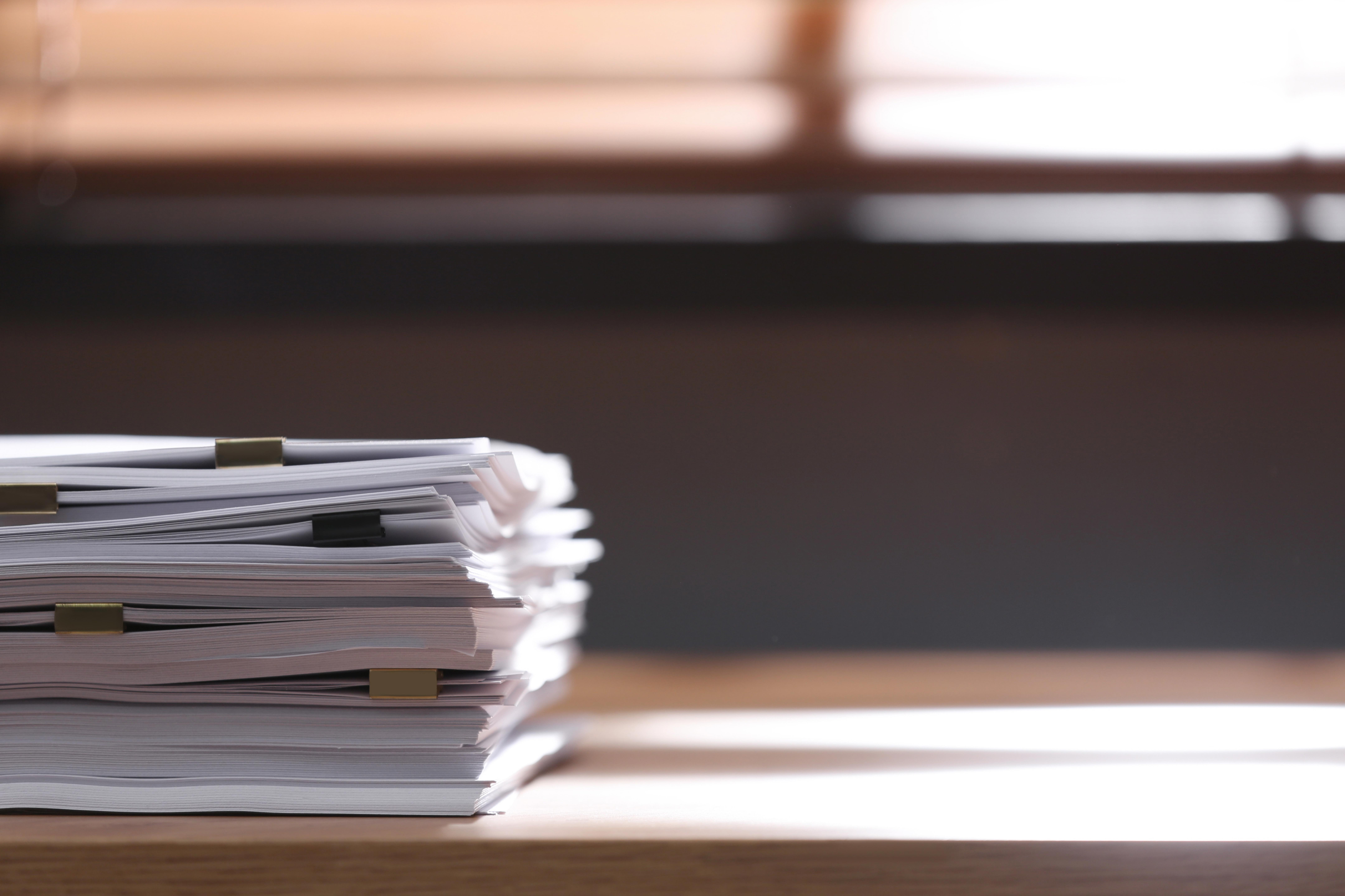 stack-of-blank-paper-with-binder-clips-on-wooden-table-indoors_8640-x-5760-px