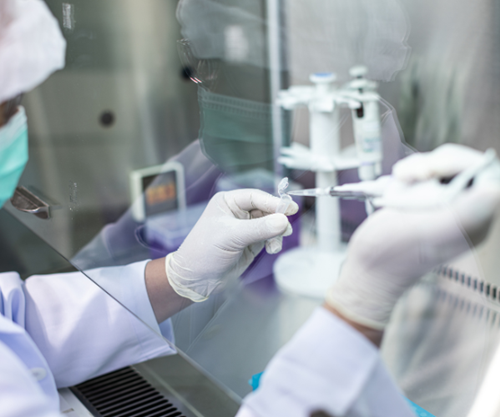 scientist-working-at-bench-in-lab-shielded-station