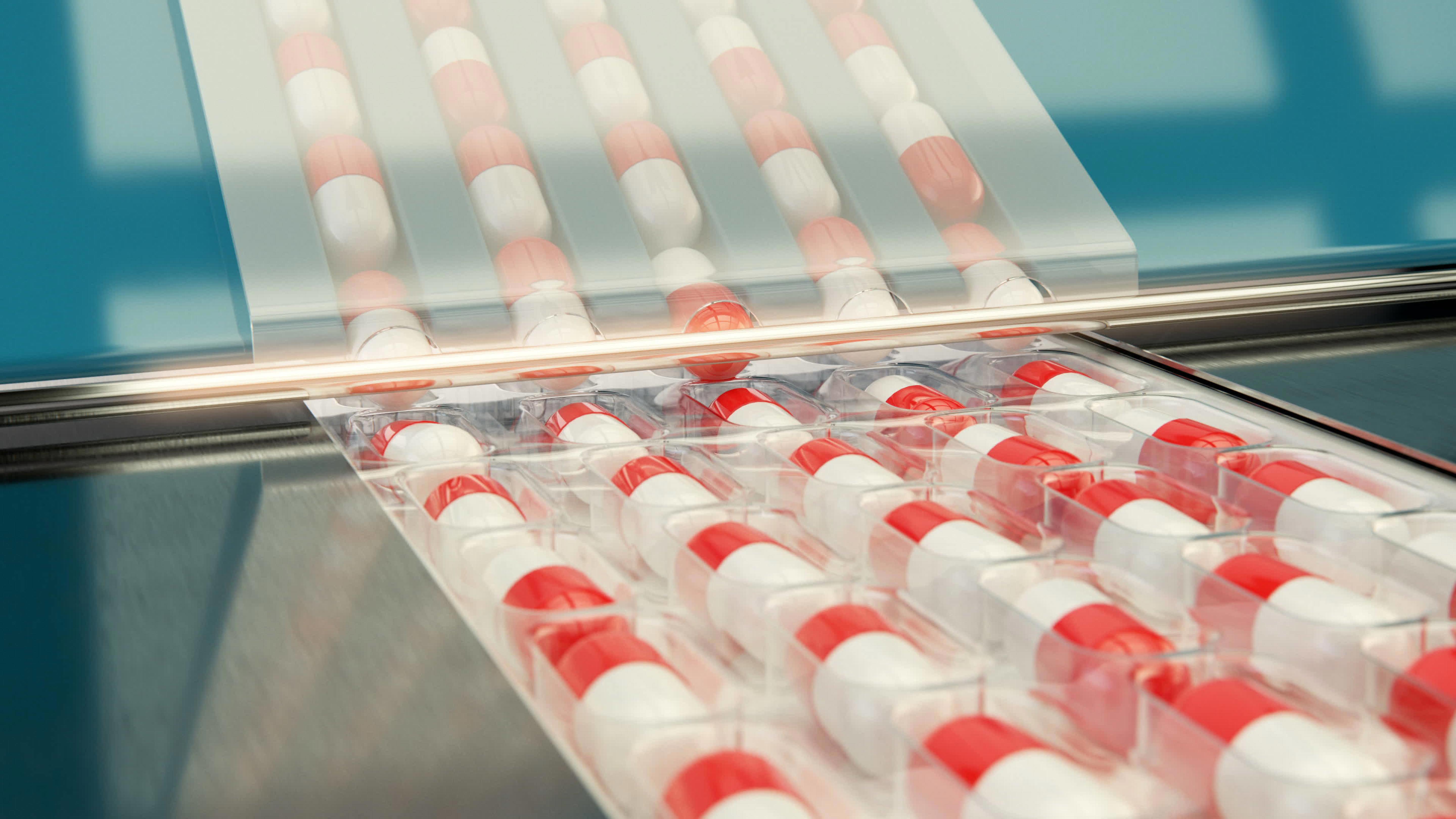 Close-up of an automated pharmaceutical packaging line where red and white capsules are sealed in transparent blister packs. The blister packs move along a conveyor under a clear protective cover, illustrating the precision and efficiency of primary packaging processes relevant to Extractables & Leachables testing by Eurofins BioPharma Product Testing.