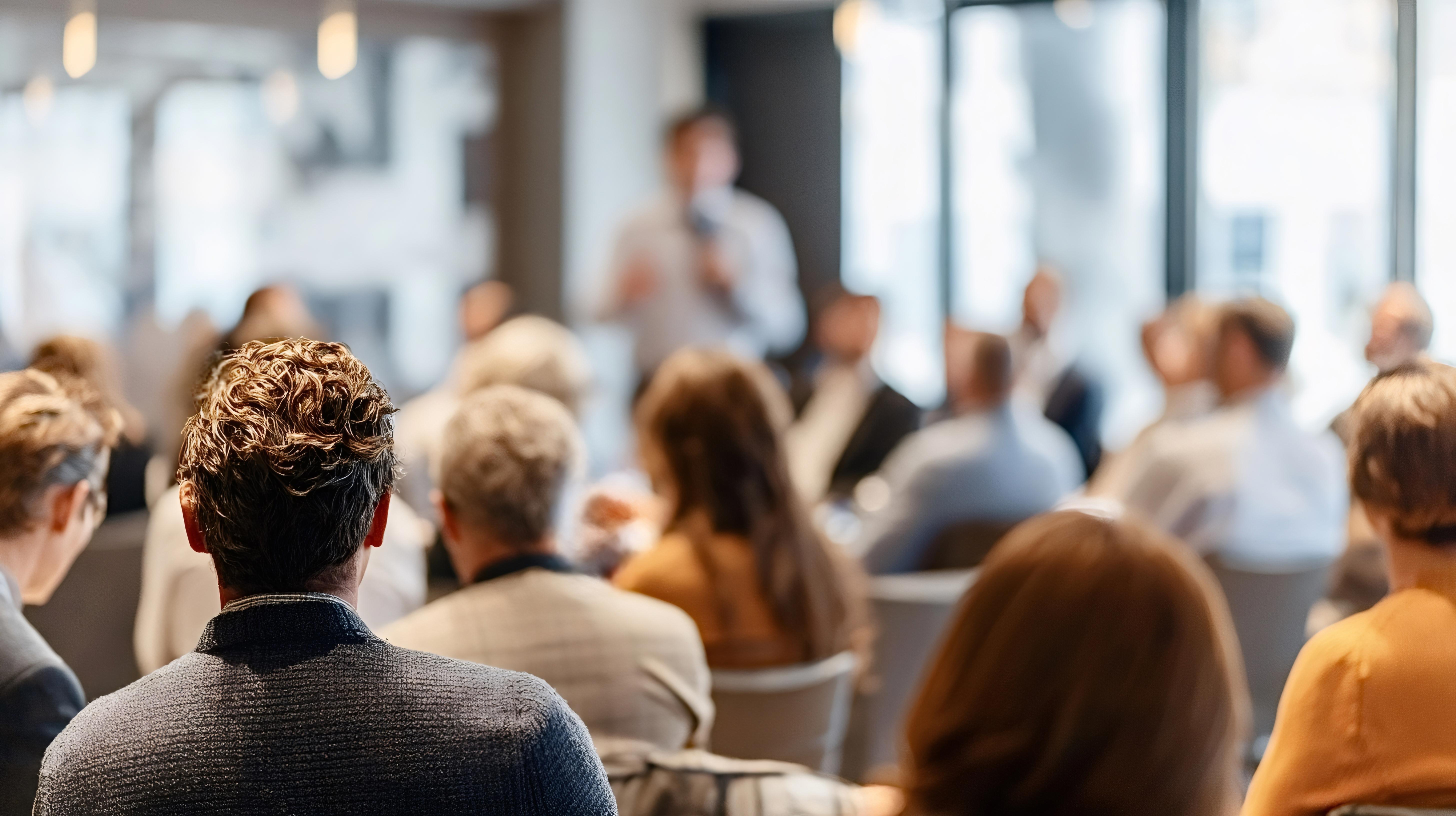 presenter-in-front-of-people-blurry-adobestock_1998647032