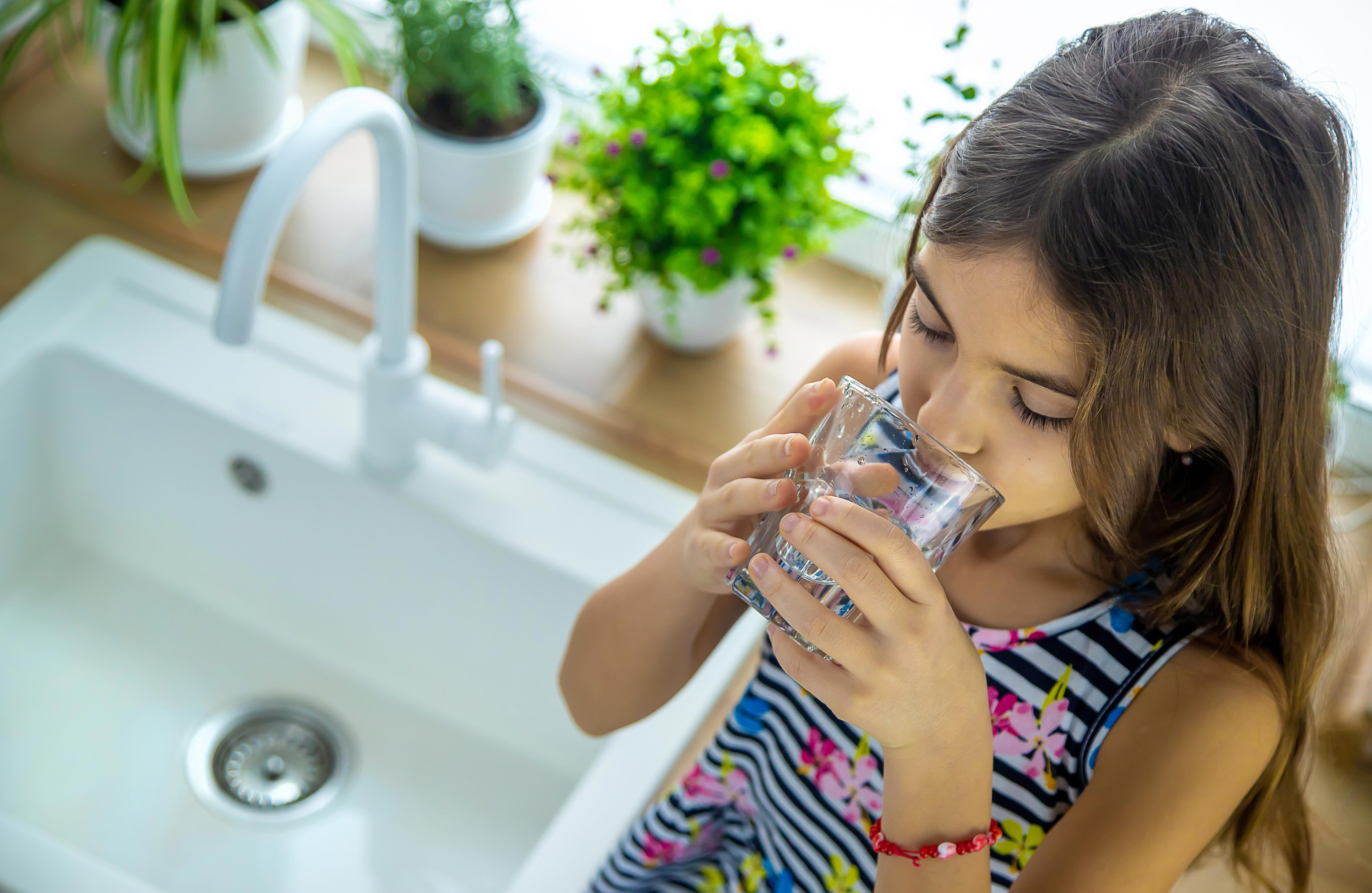 young-girl-drinking-tap-water-at-home_5832-x-3796px