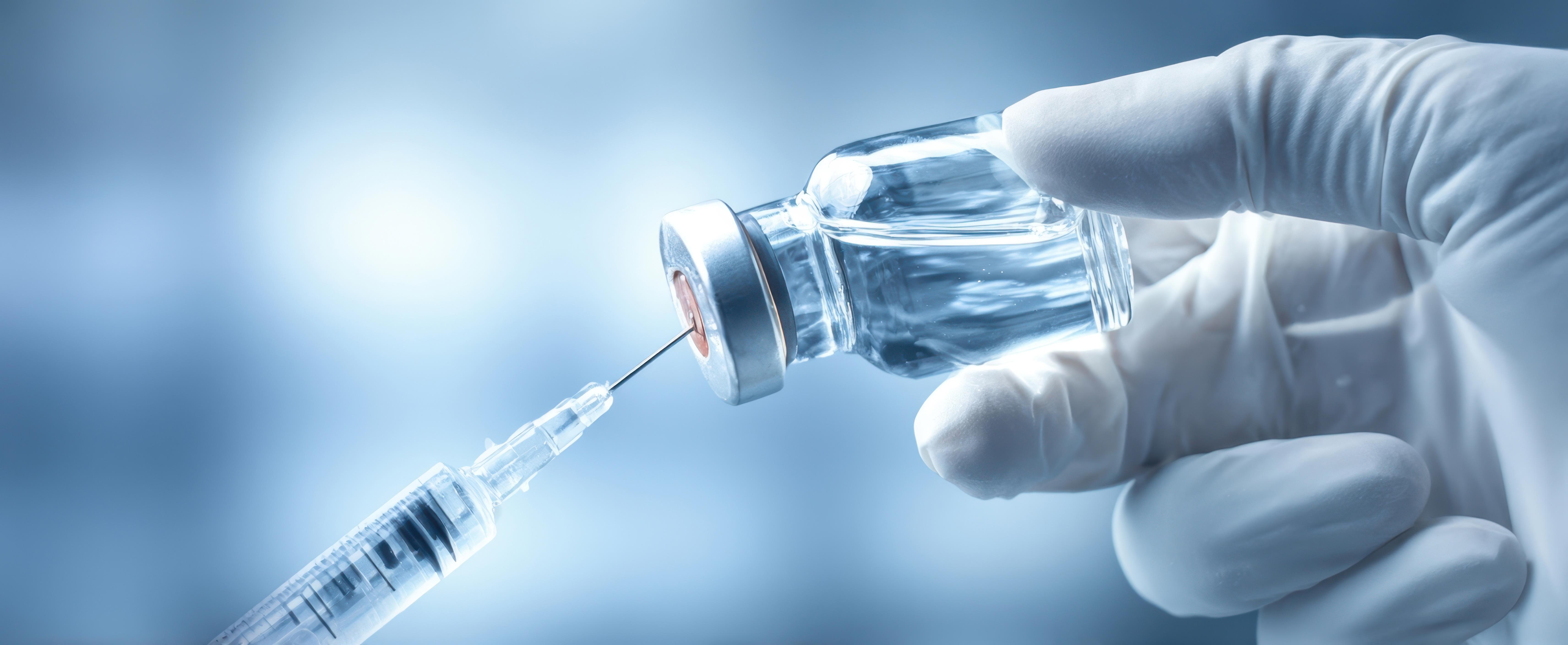 the-healthcare-professional-prepares-a-vaccine-with-a-syringe-and-a-vial_adobestock_1571354743