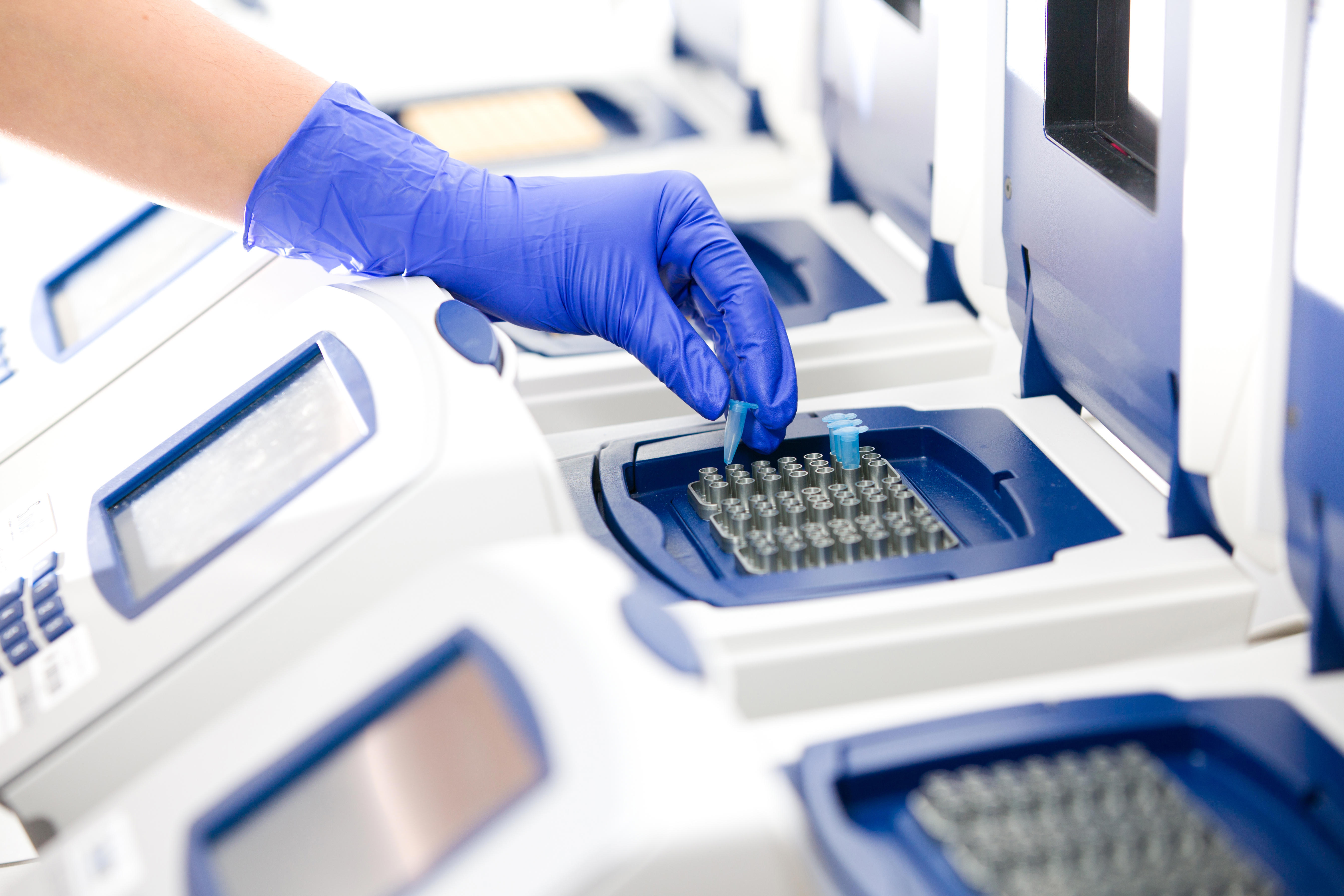 scientist-with-dna-copying-real-time-cycler-wide-adobestock_38328468